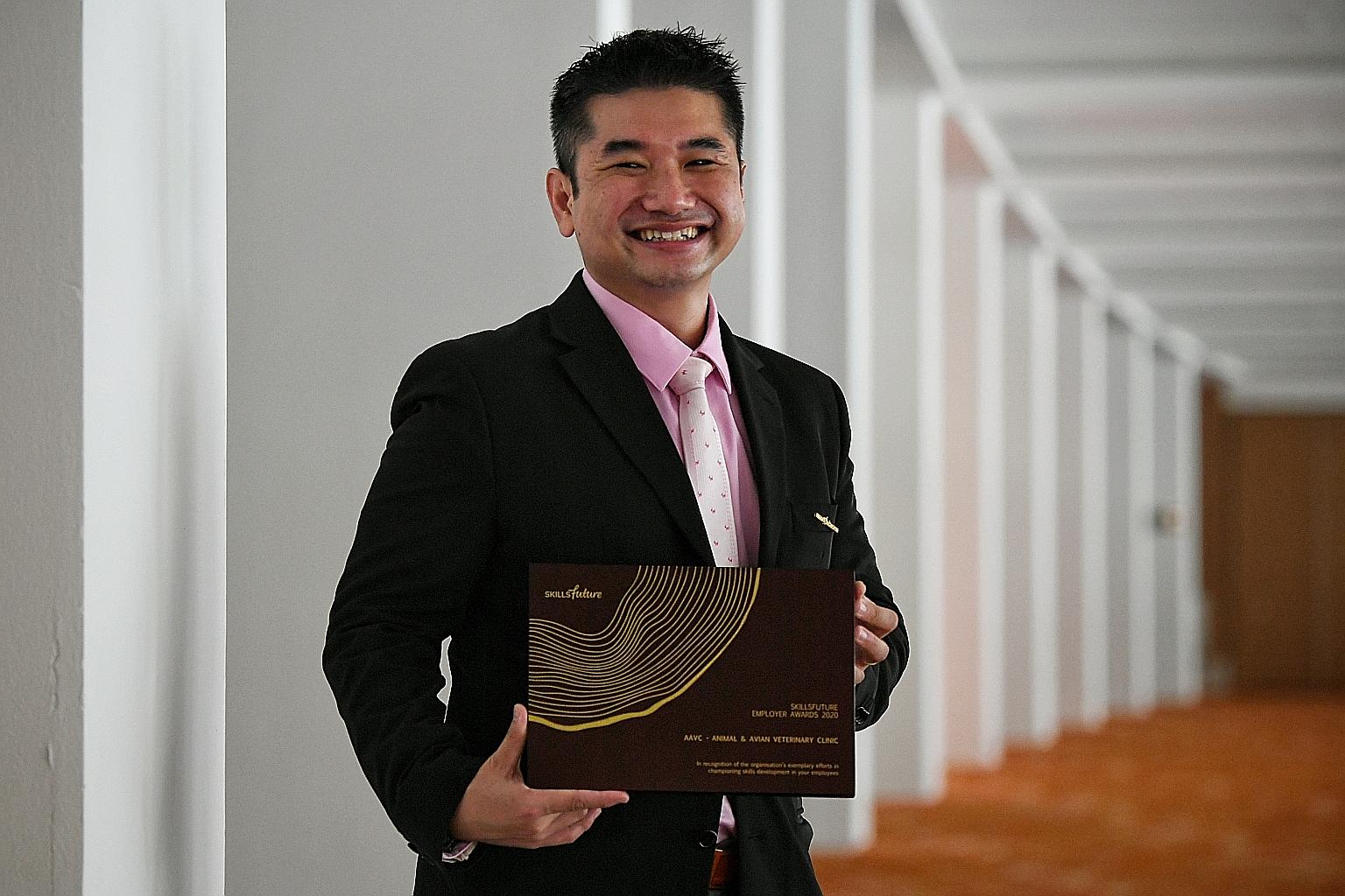 Animal and Avian Veterinary Clinic founder and head vet Kenneth Tong with his clinic's award at the fourth SkillsFuture Fellowships and Employer Awards ceremony at the Sands Expo and Convention Centre yesterday. ST PHOTO: KUA CHEE SIONG