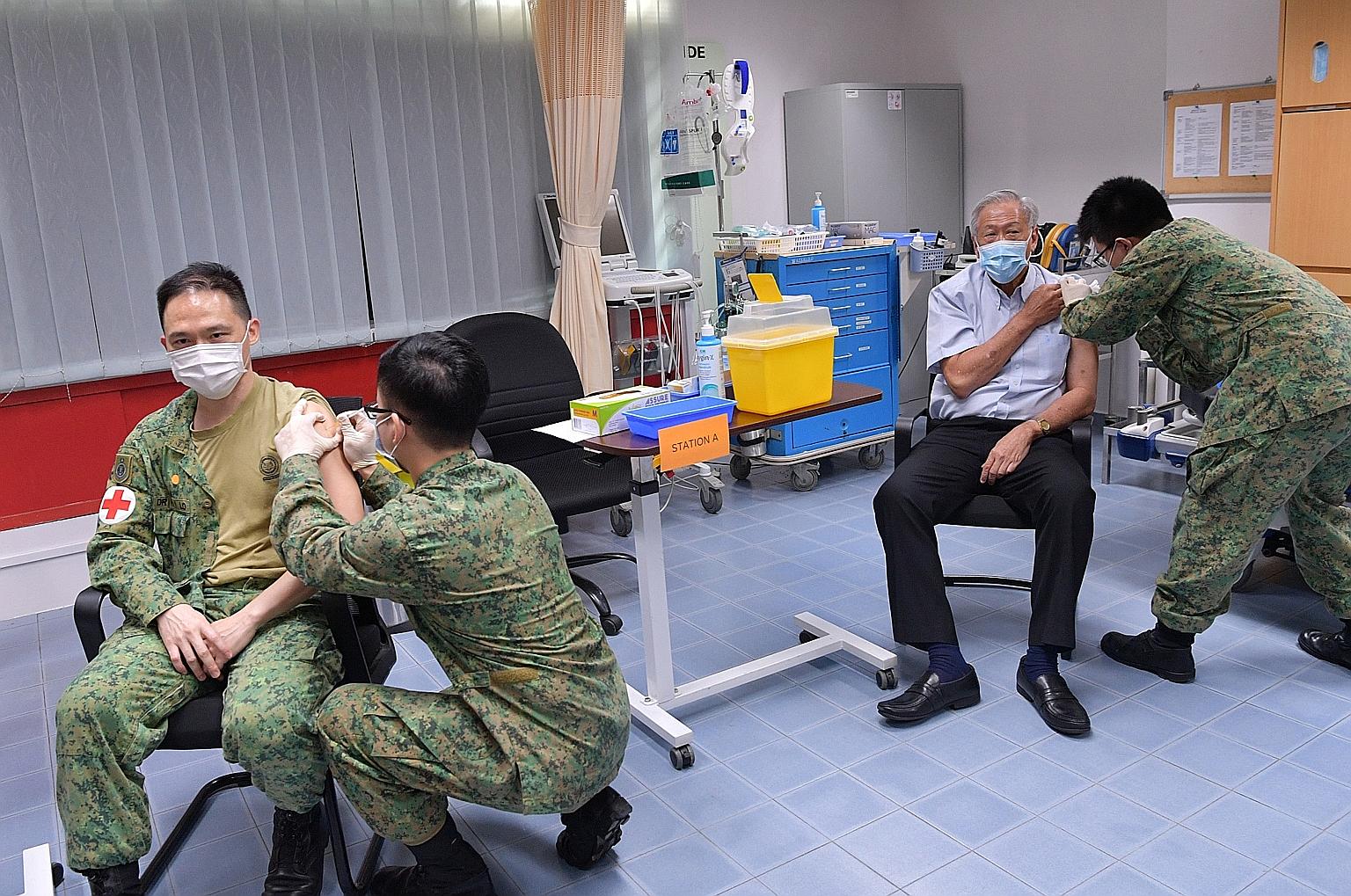 Defence Minister Ng Eng Hen (right) joined 20 Singapore Armed Forces personnel to receive the first dose of the Pfizer-BioNTech Covid-19 vaccine last week at the Mindef Medical Centre in Bukit Gombak. Senior Minister of State for Defence Zaqy Mohamad