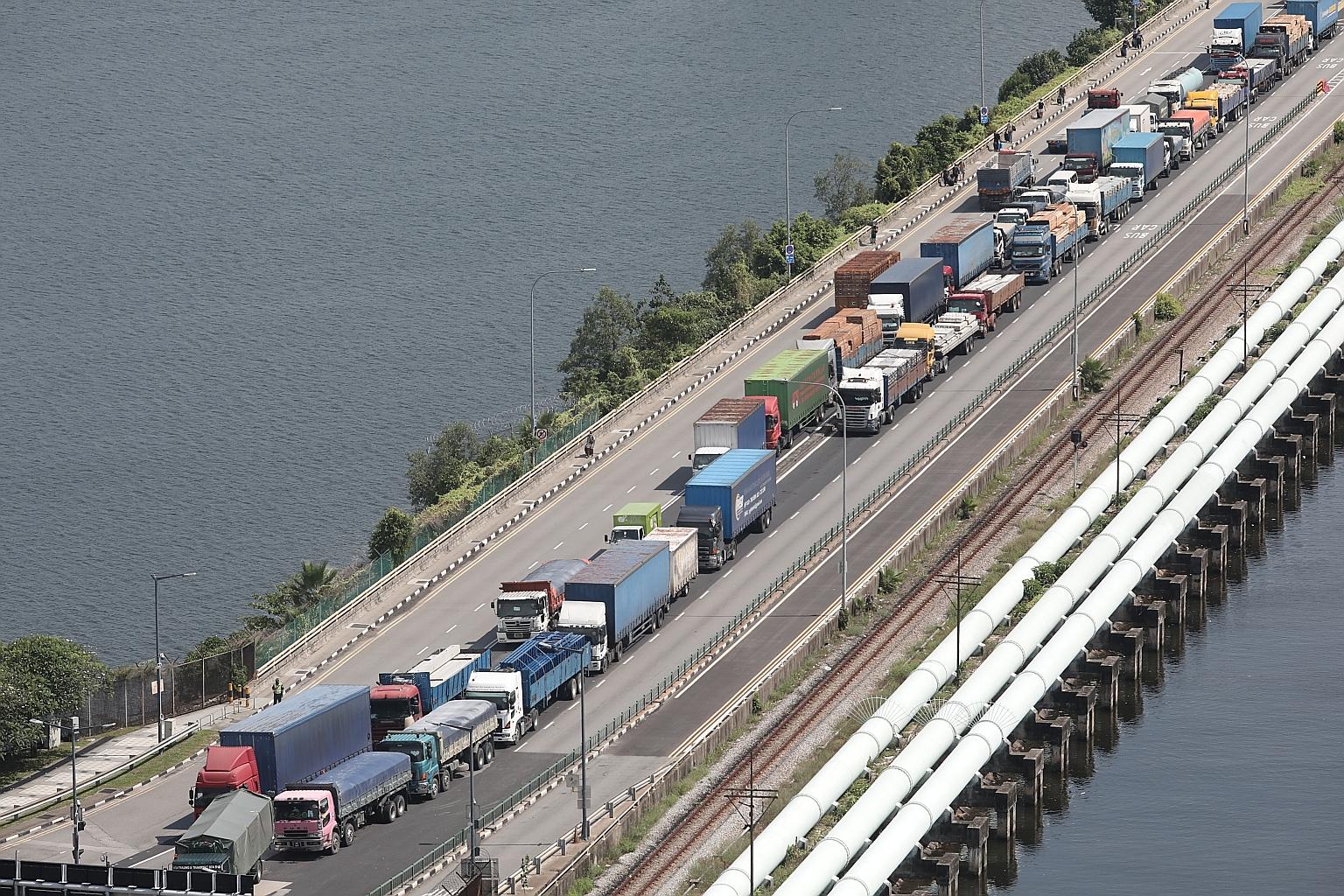 In the initial stage, cargo drivers arriving at the Woodlands (above) and Tuas checkpoints will be selected at random to be tested, said the Ministry of Trade and Industry. PHOTO: LIANHE ZAOBAO