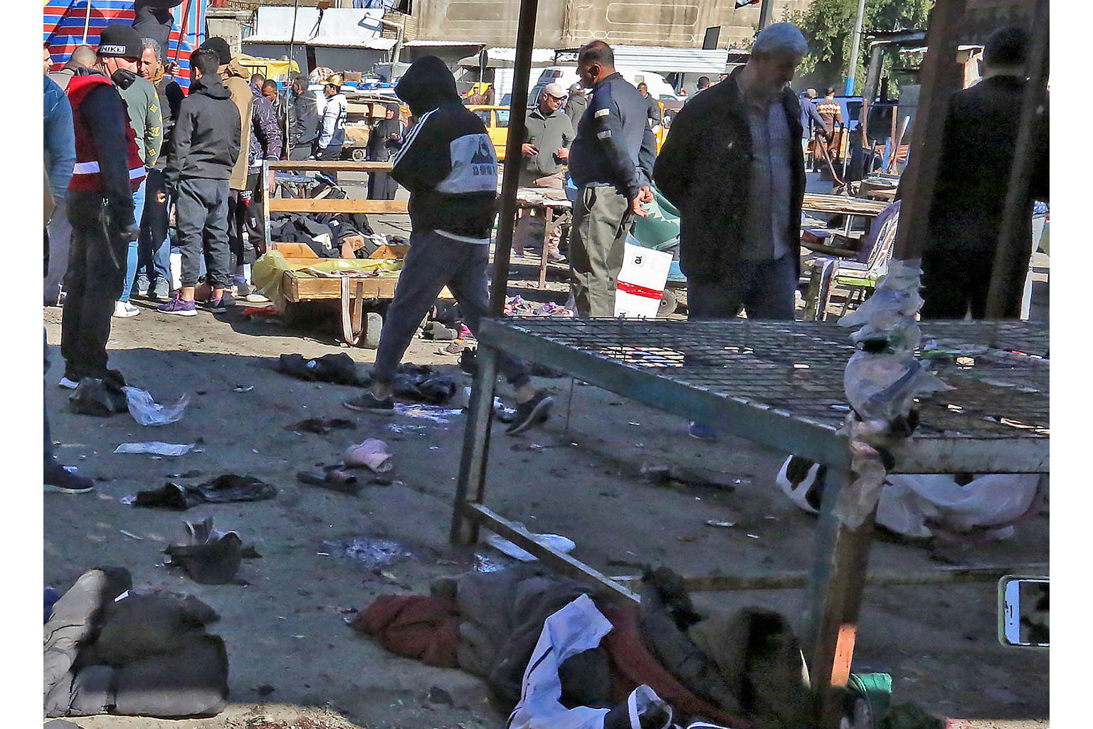 The scene after the suicide bombing yesterday in an open-air market for second-hand clothes in Baghdad's Tayaran Square. The market was teeming with people after nearly a year of pandemic curbs. PHOTO: AGENCE FRANCE-PRESSE