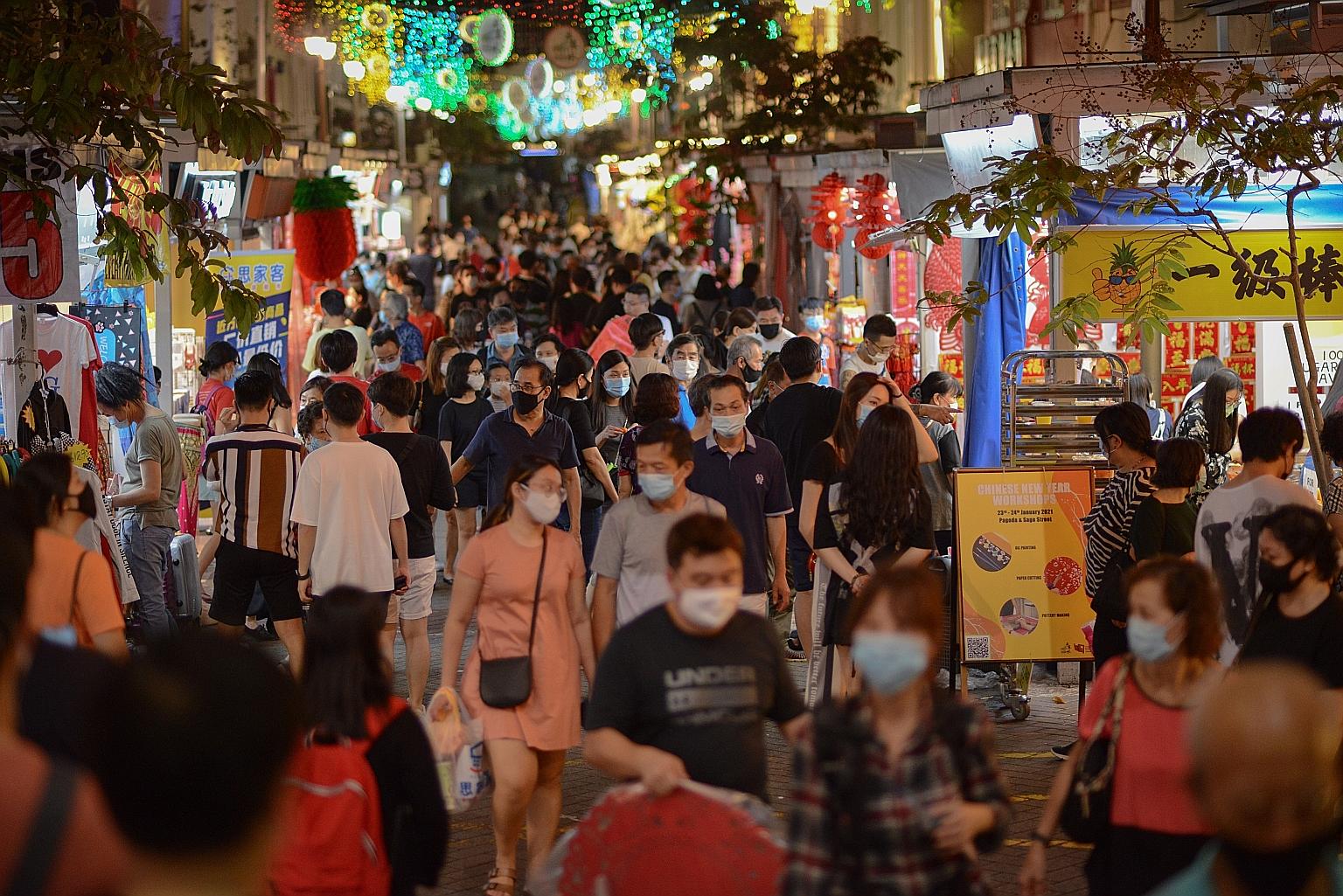 A bustling crowd of shoppers in Pagoda Street, in Chinatown, last Saturday. Education Minister Lawrence Wong urged the public to comply with the new measures.