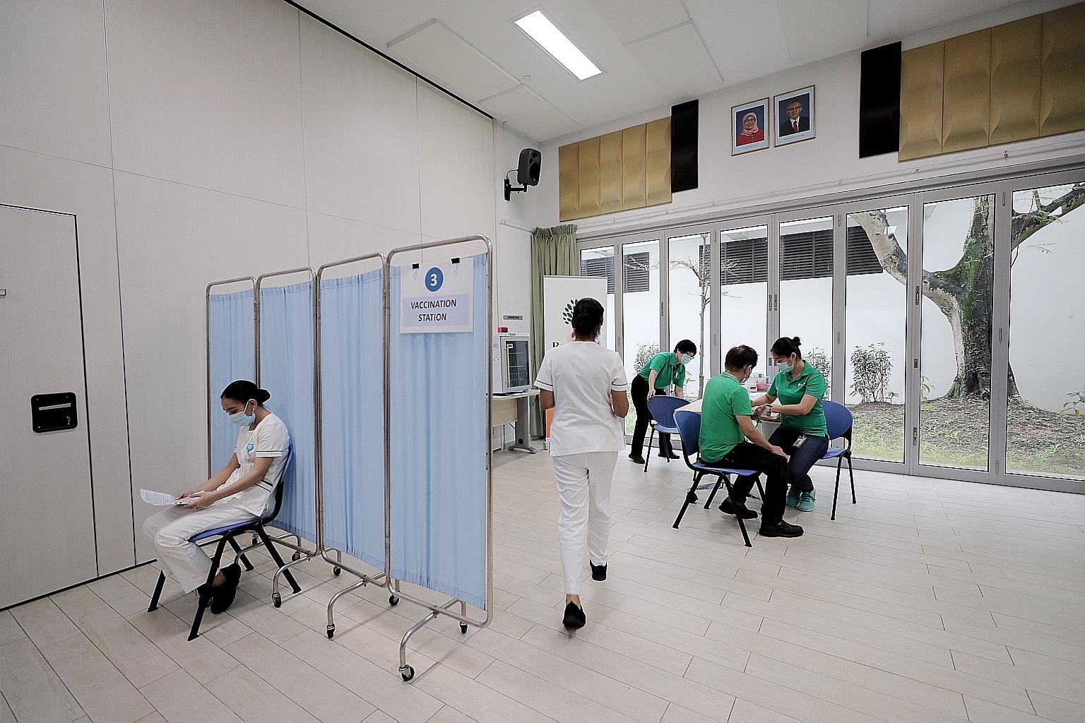 Healthcare assistants from Ren Ci @ Bukit Batok Street 52 Nursing Home receiving the Pfizer-BioNTech Covid-19 vaccine on Jan 11. The Health Ministry said there will be some delays in shipments of the Pfizer-BioNTech vaccine because of upgrading works