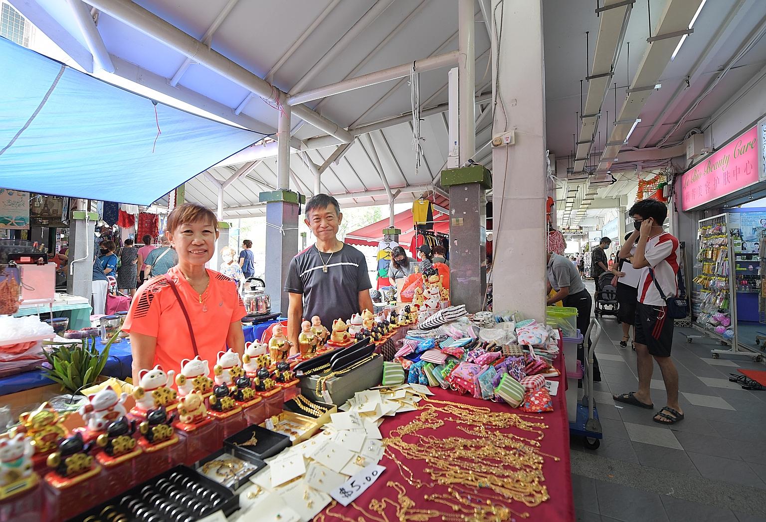 Mr Teo Beng Koon and his sister Ah Gim at their stall in a sub-leased outdoor display area in Ang Mo Kio. He says the ban on pasar malams and mall atrium sales has led to higher rentals for outdoor display areas.
