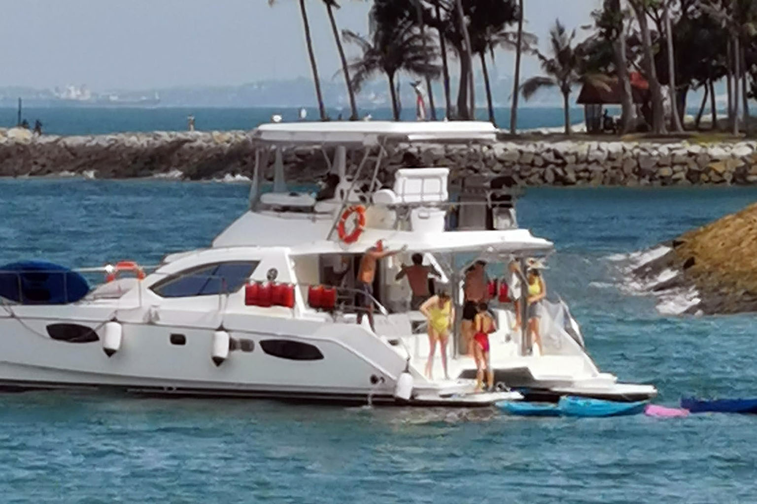 Screengrab from a video on Facebook showing a group of at least 10 people on a pleasure craft near Lazarus Island on Dec 26. In the 15-second video, the group of men and women could be seen dancing without wearing masks. PHOTO: BU HUI YAN/FACEBOOK