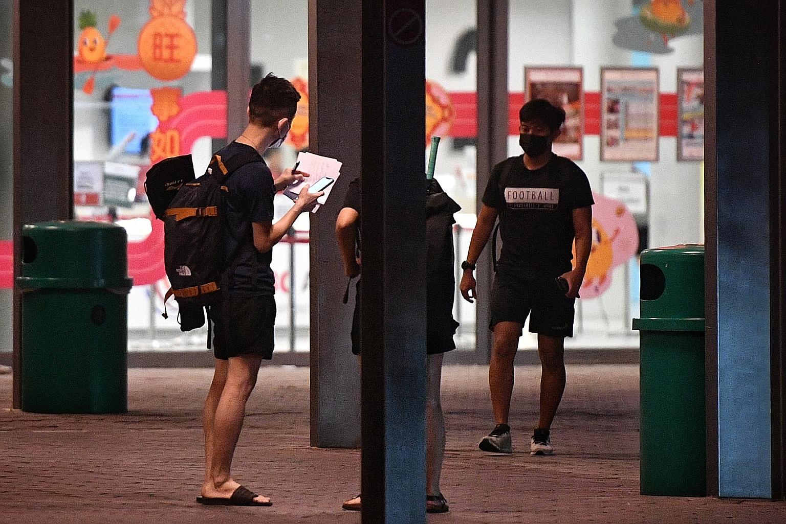 "Andrew" assigning courts and collecting money from social badminton players outside the OCBC Arena before signing them in. There is consternation among enthusiasts as they are unable to book the facilities and they suspect that resellers are snappin