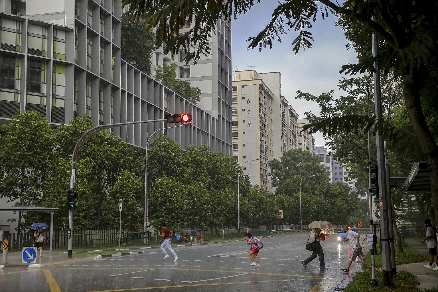 Pedestrians making a dash for shelter amid heavy rain at a traffic junction in Woodlands Ring Road last Thursday. As at last Wednesday, 648.4mm of rain had fallen in Singapore, said the weatherman. The all-time high for January rainfall of 818.6mm wa