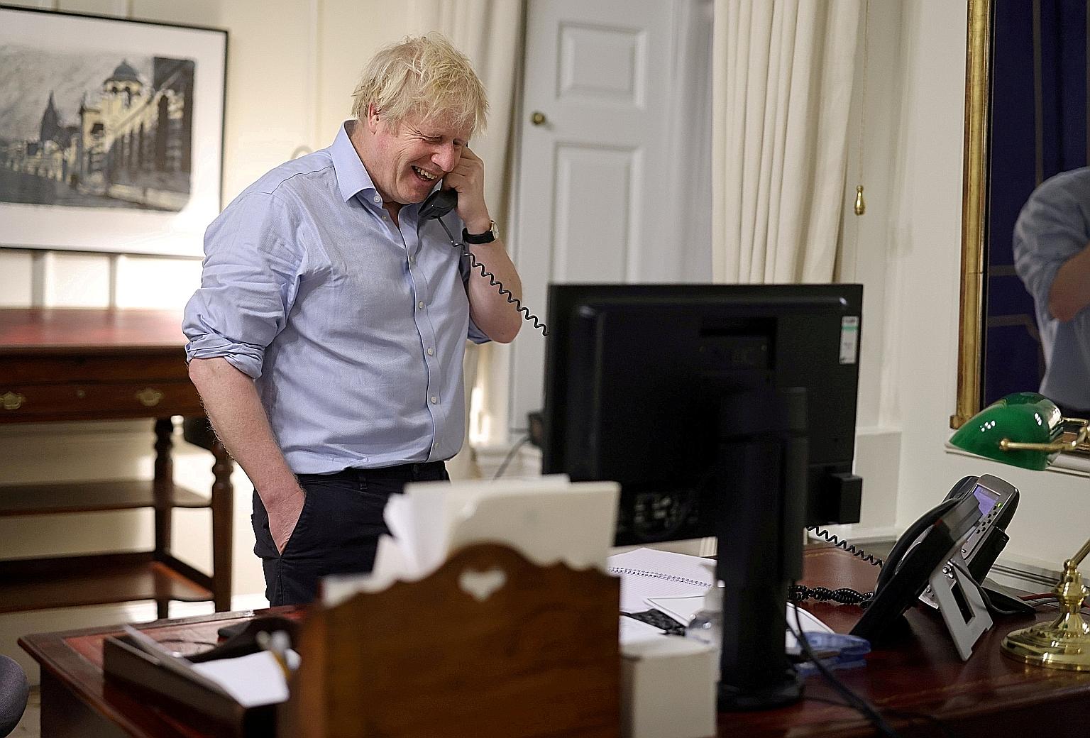 British Prime Minister Boris Johnson tweeted a picture of himself laughing as he spoke on the phone to US President Joe Biden on Saturday. 