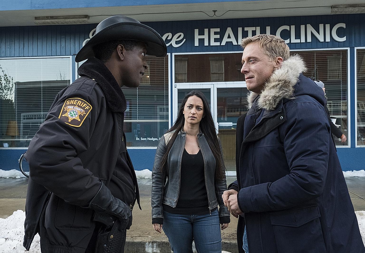 (From left) Corey Reynolds, Sara Tomko and Alan Tudyk in Resident Alien.