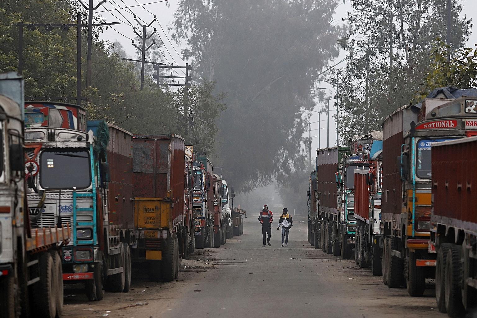 Trucks lined up at the Delhi-Ghaziabad border in New Delhi yesterday. Farmers have blockaded approaches into the Indian capital for about two months to protest against new laws that they say will hurt their livelihoods.