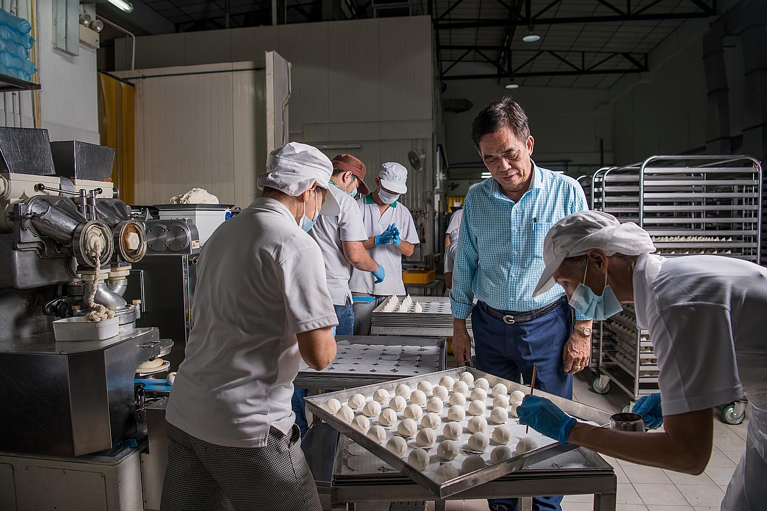 Workers making Chinese buns at Lim Kee Food Manufacturing's facility in Woodlands in this file photo. It is working on getting products registered with the local Chinese authorities. 