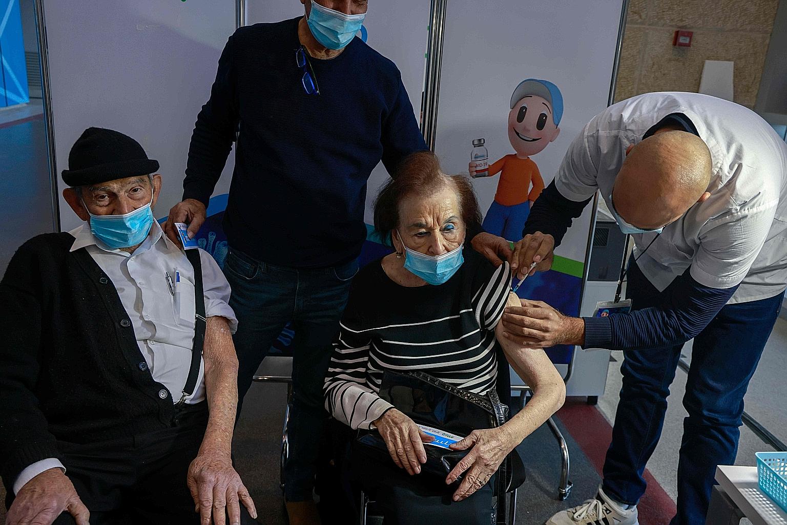 A woman receiving a dose of the Pfizer-BioNTech vaccine at Clalit Health Services in Jerusalem on Sunday. The Israeli Health Ministry found that out of 428,000 Israelis who had received their second doses, only 63 - or 0.014 per cent - contracted the