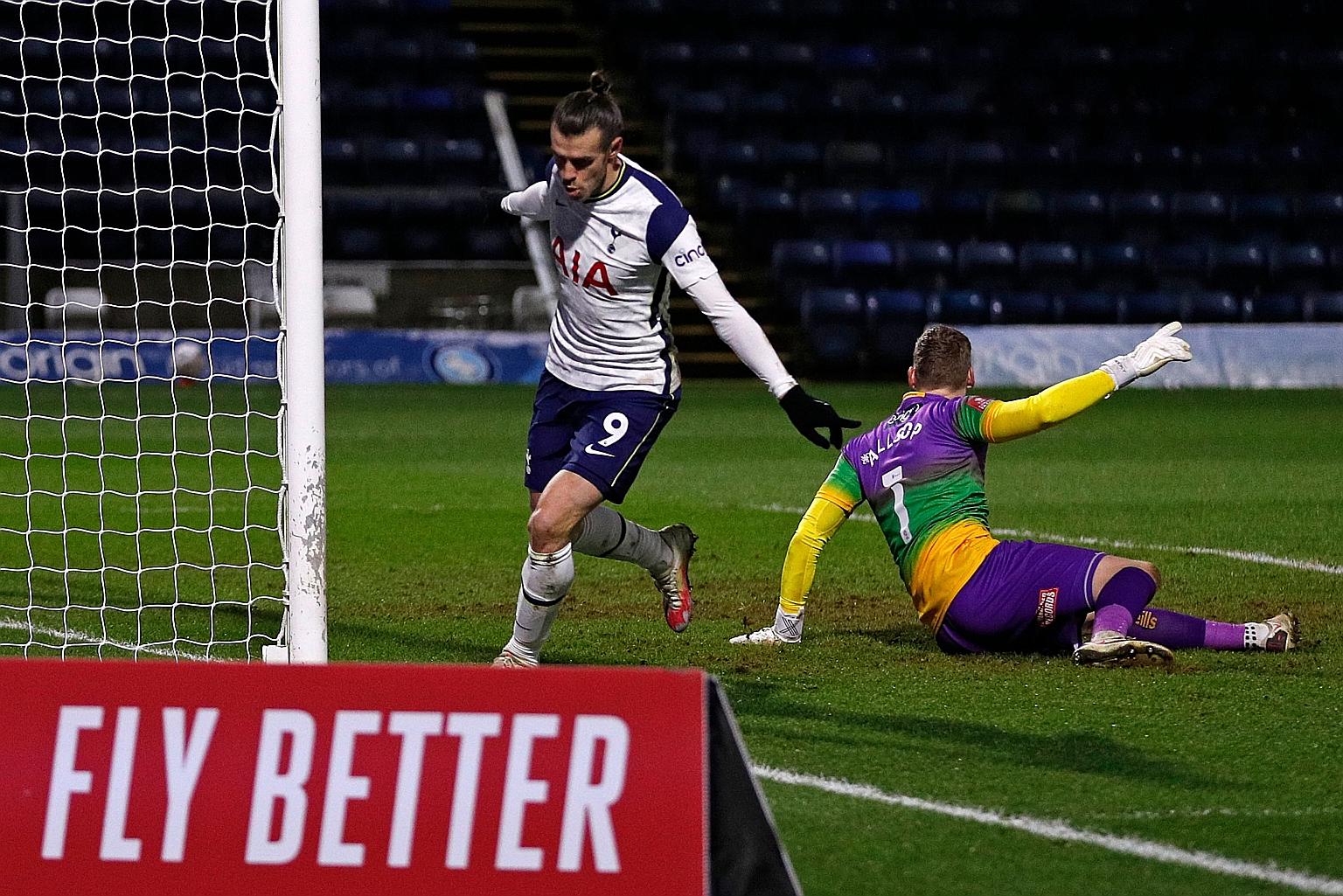 Gareth Bale celebrates nodding in Tottenham's equaliser against Championship side Wycombe. Spurs' 4-1 win earned them a trip to Goodison Park to play Everton in the fifth round of the FA Cup.