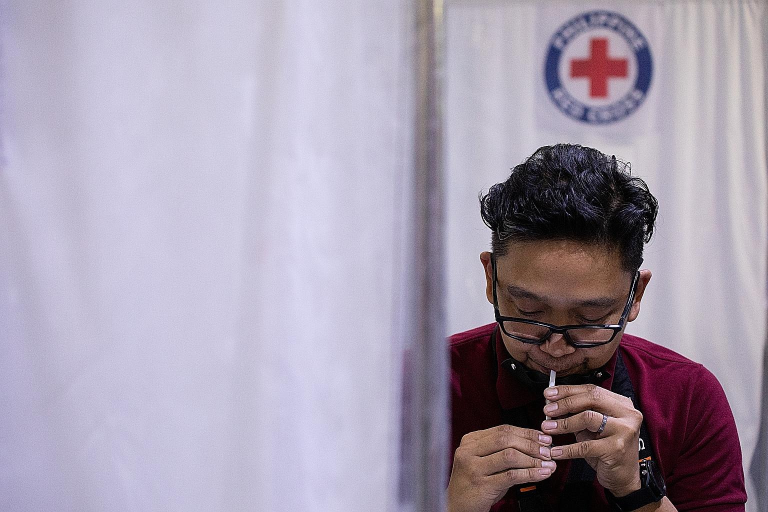A man giving a saliva sample to test for Covid-19 at a laboratory in Mandaluyong City, Metro Manila, on Monday. The Philippines' caseload of more than half a million infections is one of the highest in South-east Asia.