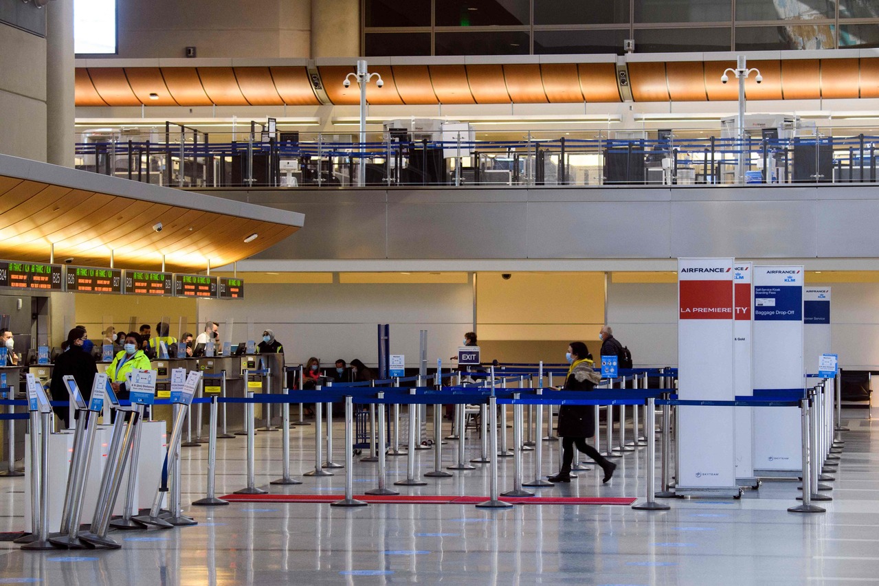 Passengers check-in for a flight at the Air France and KLM counter at Los Angeles International Airport amid increased Covid-19 travel restrictions, on Jan 25, 2021.