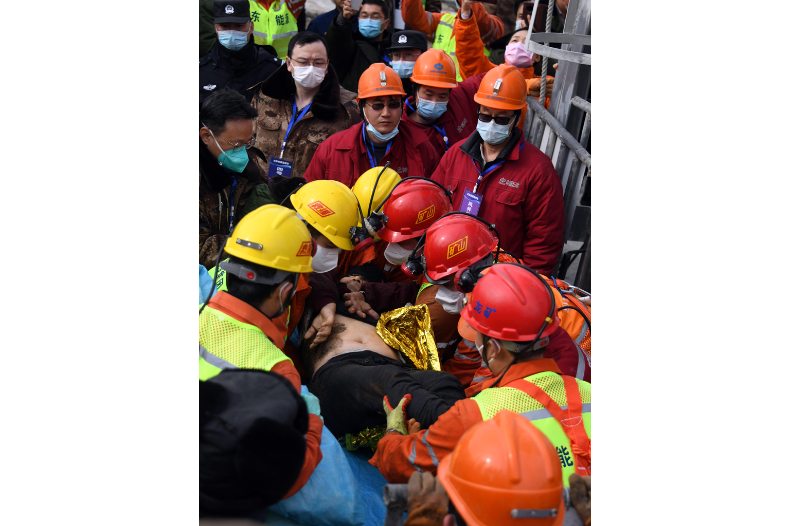 One of the miners at the Hushan mine in Shandong province being taken to safety yesterday. A blast at the mine on Jan 10 trapped 22 miners about 600m underground. One miner is known to have died and 10 are unaccounted for.