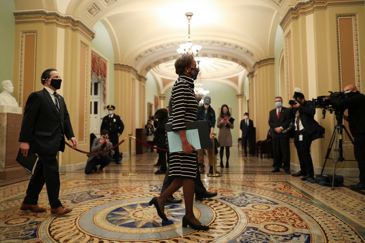 US House of Representatives clerk Cheryl Johnson holding the article of impeachment against former President Donald Trump in the US Capitol on Jan 25, 2021. 