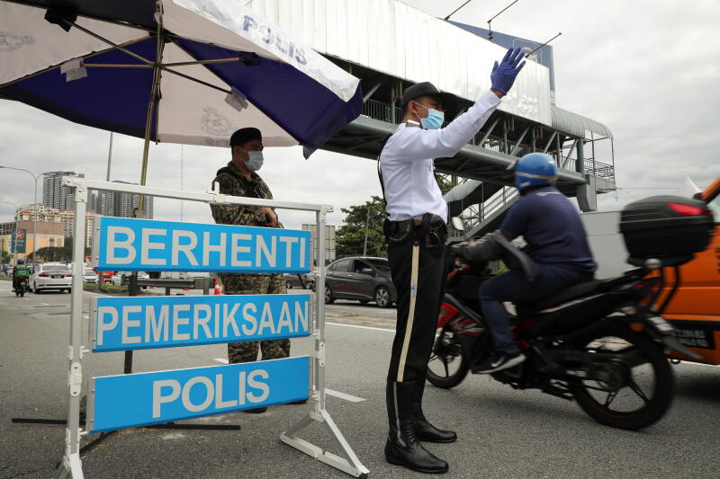 Security officers manning a roadblock in Kuala Lumpur, amid the country's movement control order, on Jan 13, 2021.
