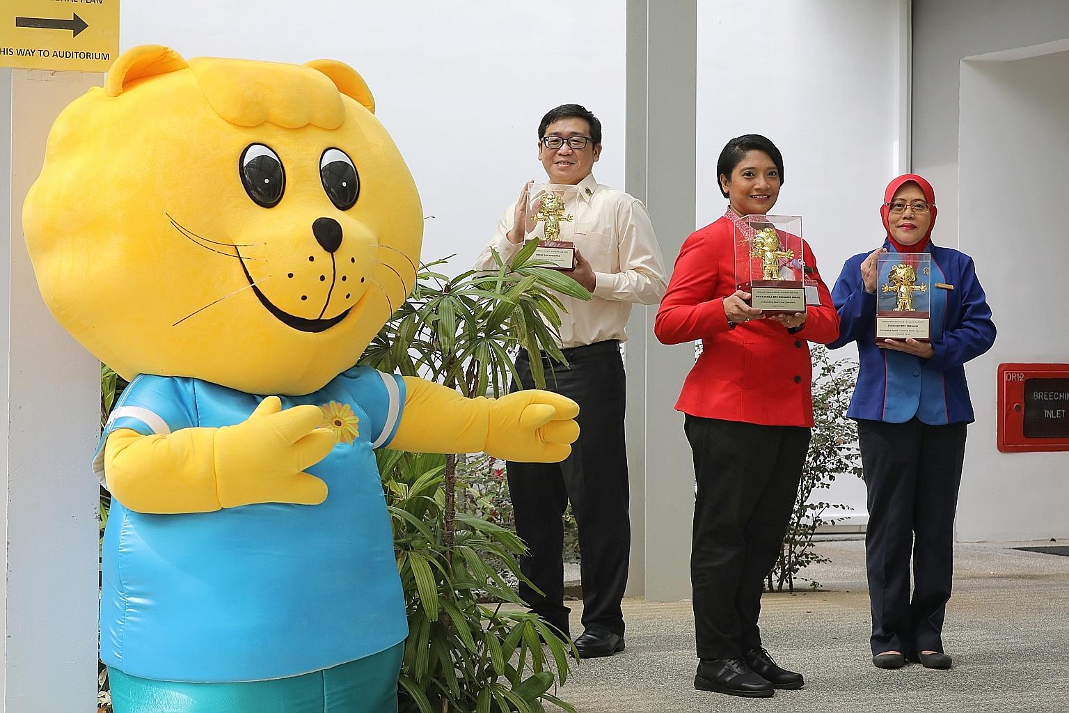 Among the award recipients yesterday are (from left) taxi driver Henry Koh, SMRT assistant station manager Suhaila Ismail and TransitLink customer service officer Zubaidah Ebrahim, who went to a commuter's house to return his lost wallet. They are se