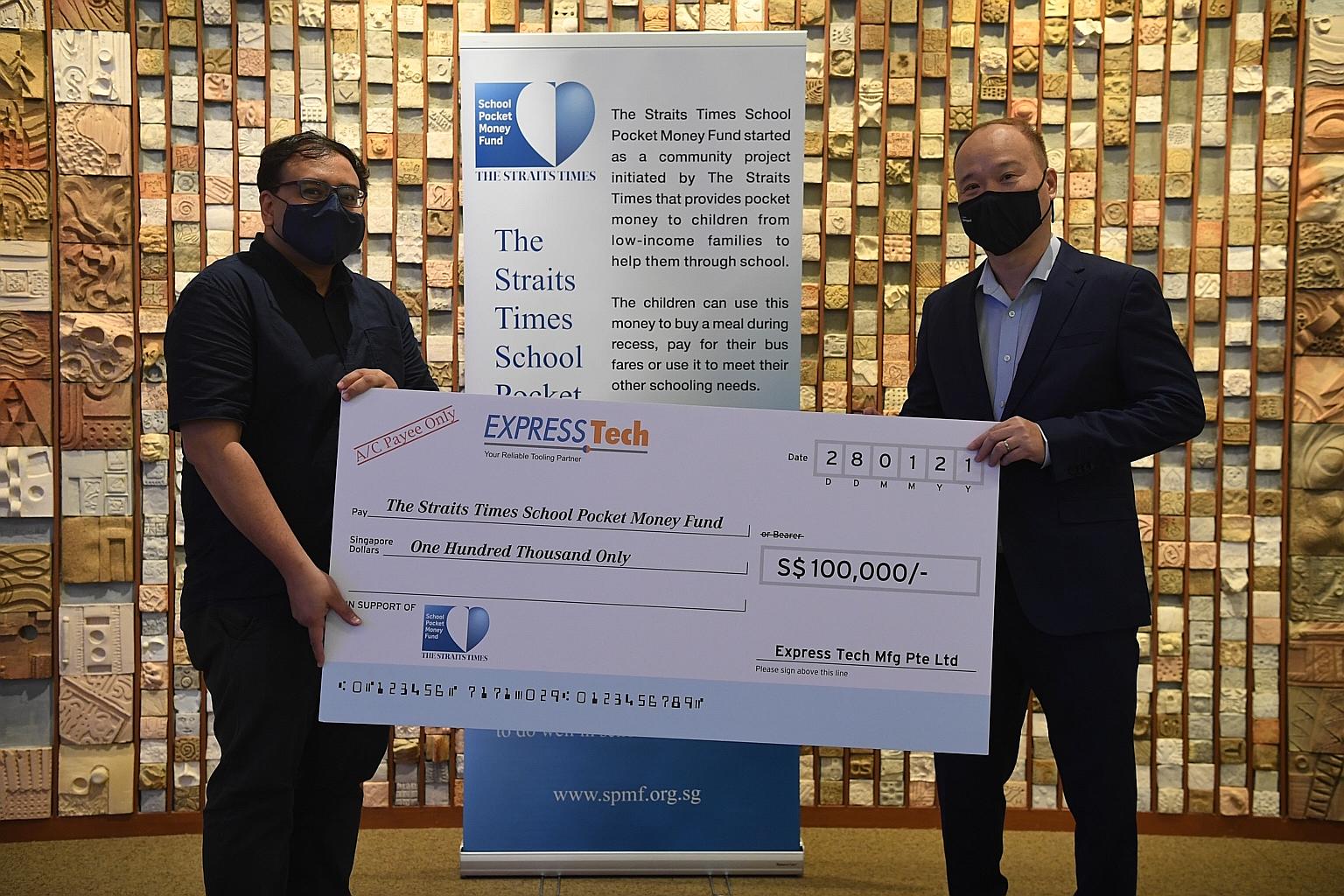 Mr Leong Yoke Ming, managing director of Express Tech Manufacturing, handing a mock cheque of $100,000 to Mr Zakir Hussain, a board trustee of STSPMF and ST's Singapore editor, at SPH News Centre yesterday. ST PHOTO: KUA CHEE SIONG