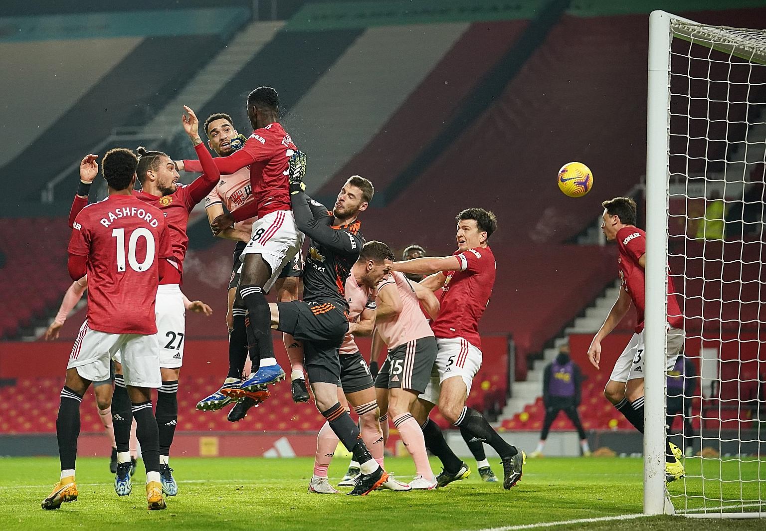 Bottom side Sheffield United's Kean Bryan (third from left) heading their opening goal against Manchester United at Old Trafford on Wednesday. The hosts' supporting cast did not rise to the occasion and manager Ole Gunnar Solskjaer is set to revert t