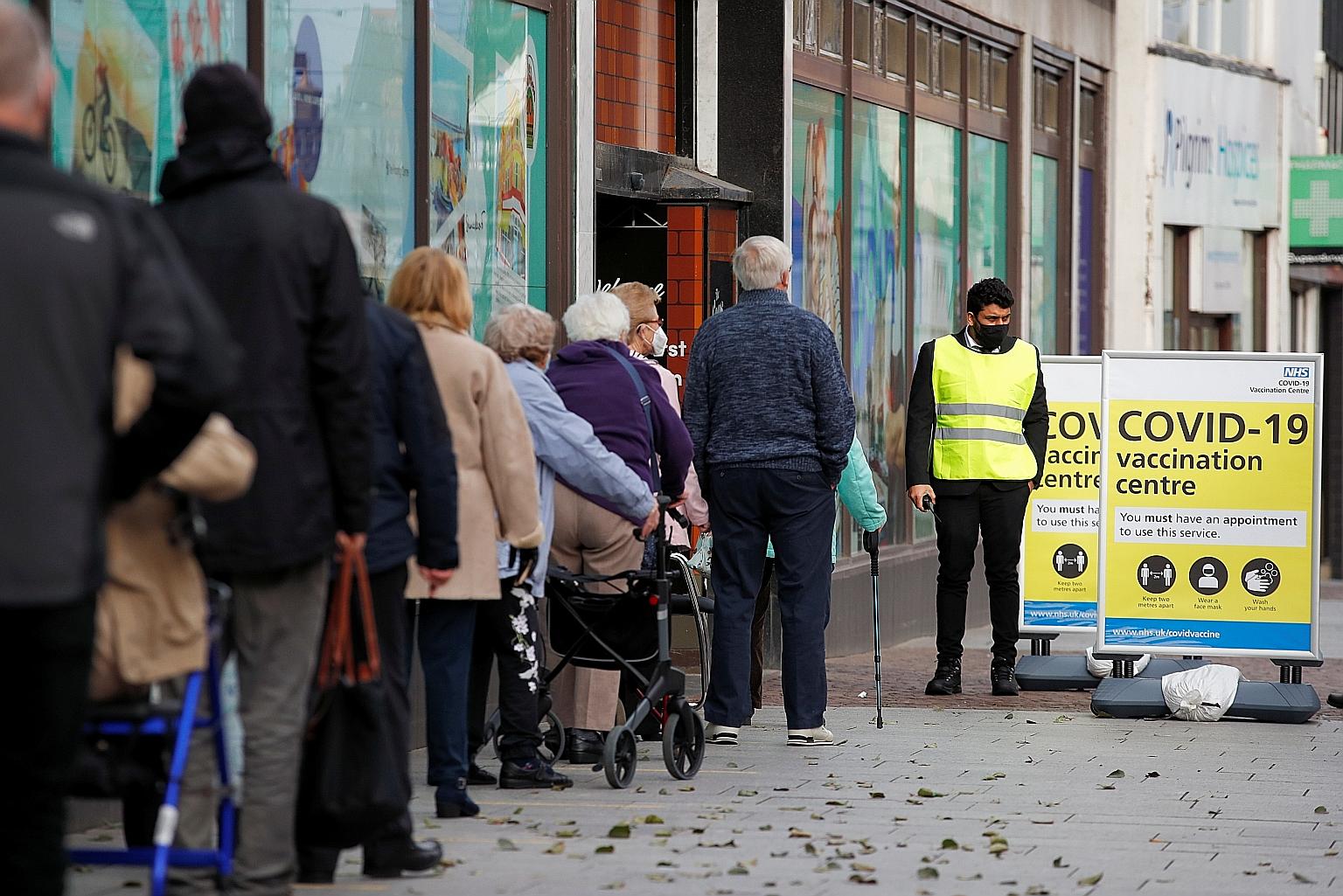 People queueing for Covid-19 vaccinations this week outside a store serving as a vaccination centre in Kent, Britain. US biotechnology firm Novavax said its two-shot Covid-19 vaccine showed an overall efficacy of 89.3 per cent in a major phase three 