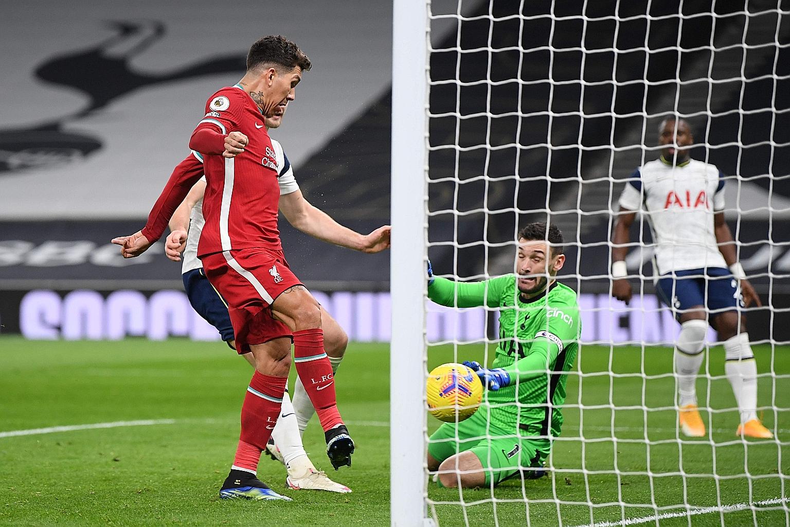 Liverpool's Brazilian striker Roberto Firmino scoring the opening goal during the English Premier League match against Tottenham Hotspur in London on Thursday. Trent Alexander-Arnold and Sadio Mane were also on the scoresheet in Liverpool's 3-1 victo