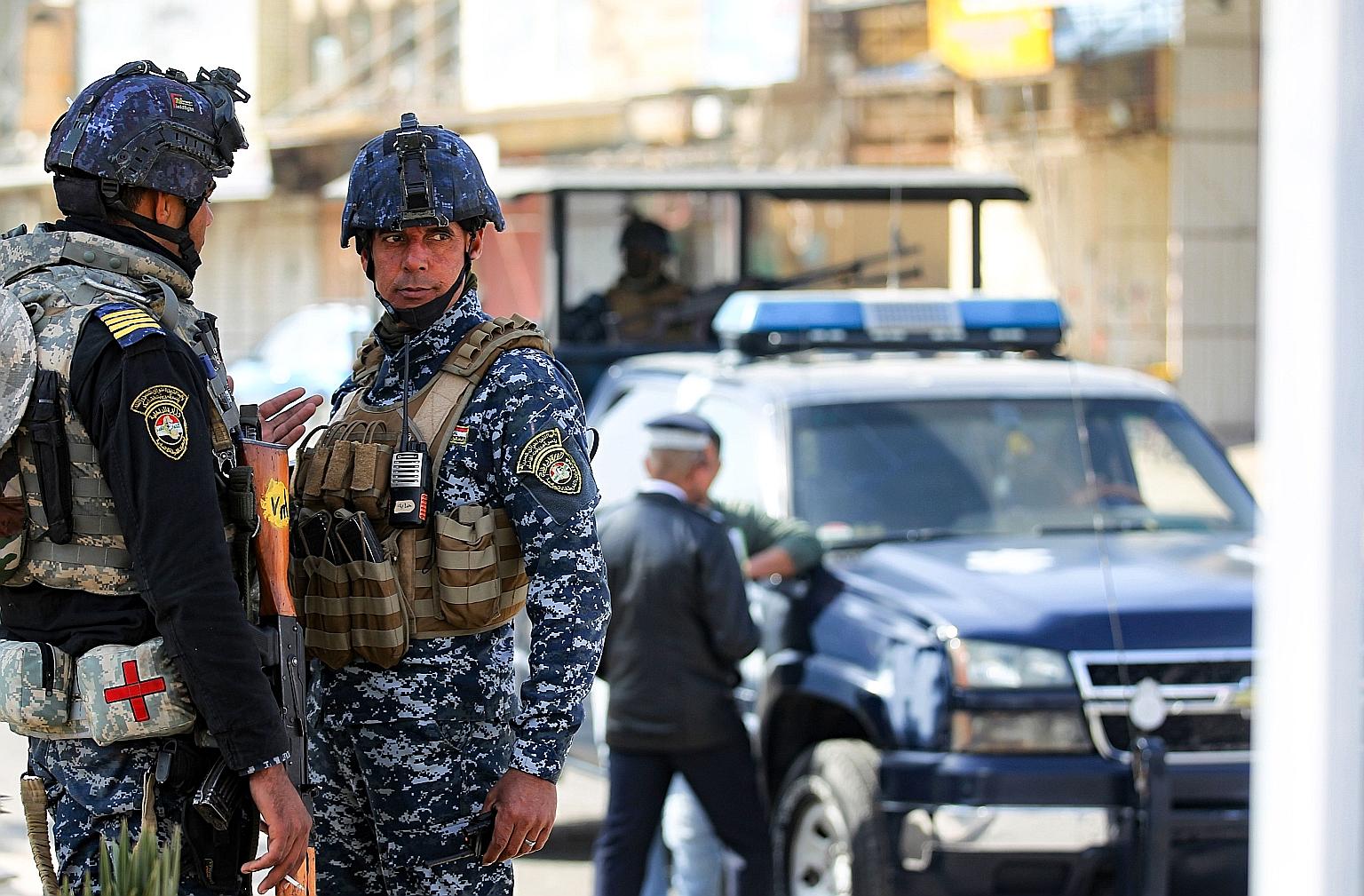 Iraqi federal police at a checkpoint in Baghdad on Friday, during tightened security measures imposed after a man identified as a top ISIS leader in Iraq - Jabbar Salman Ali Farhan al-Issawi, also known as Abu Yasser - was killed during a United Stat