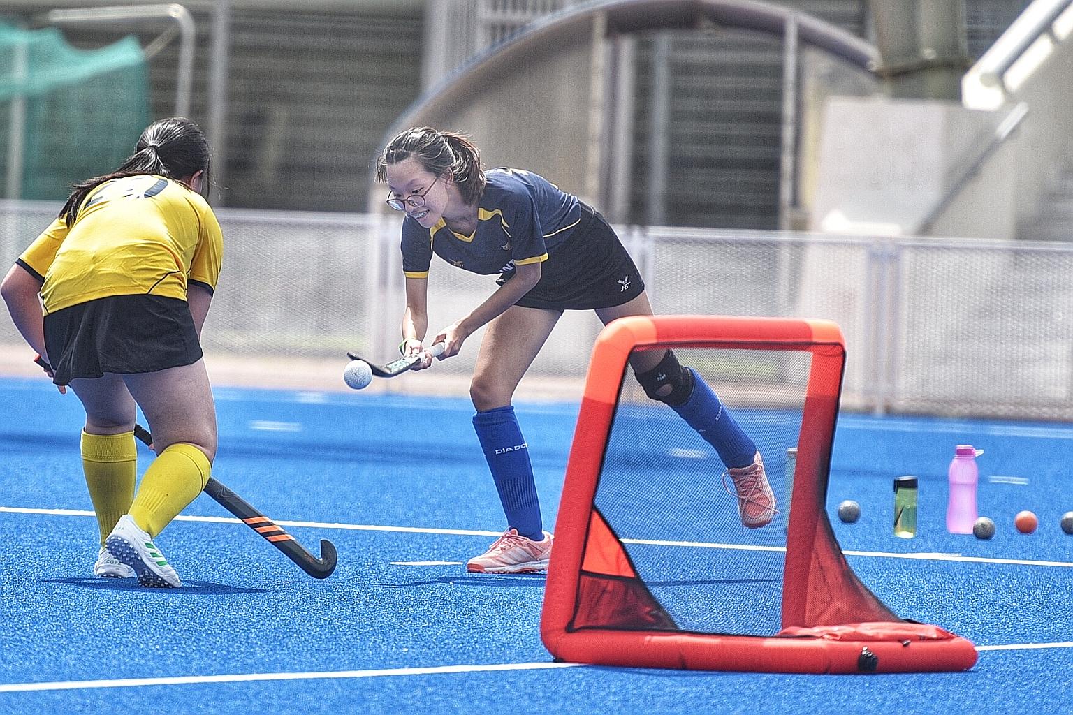 Oldham B's Tanya Lee controlling the ball during the match against Oldham D in the Under-19 3v3 league at the Sengkang Hockey Stadium yesterday. The 18-year-old scored seven goals in the 9-6 win.