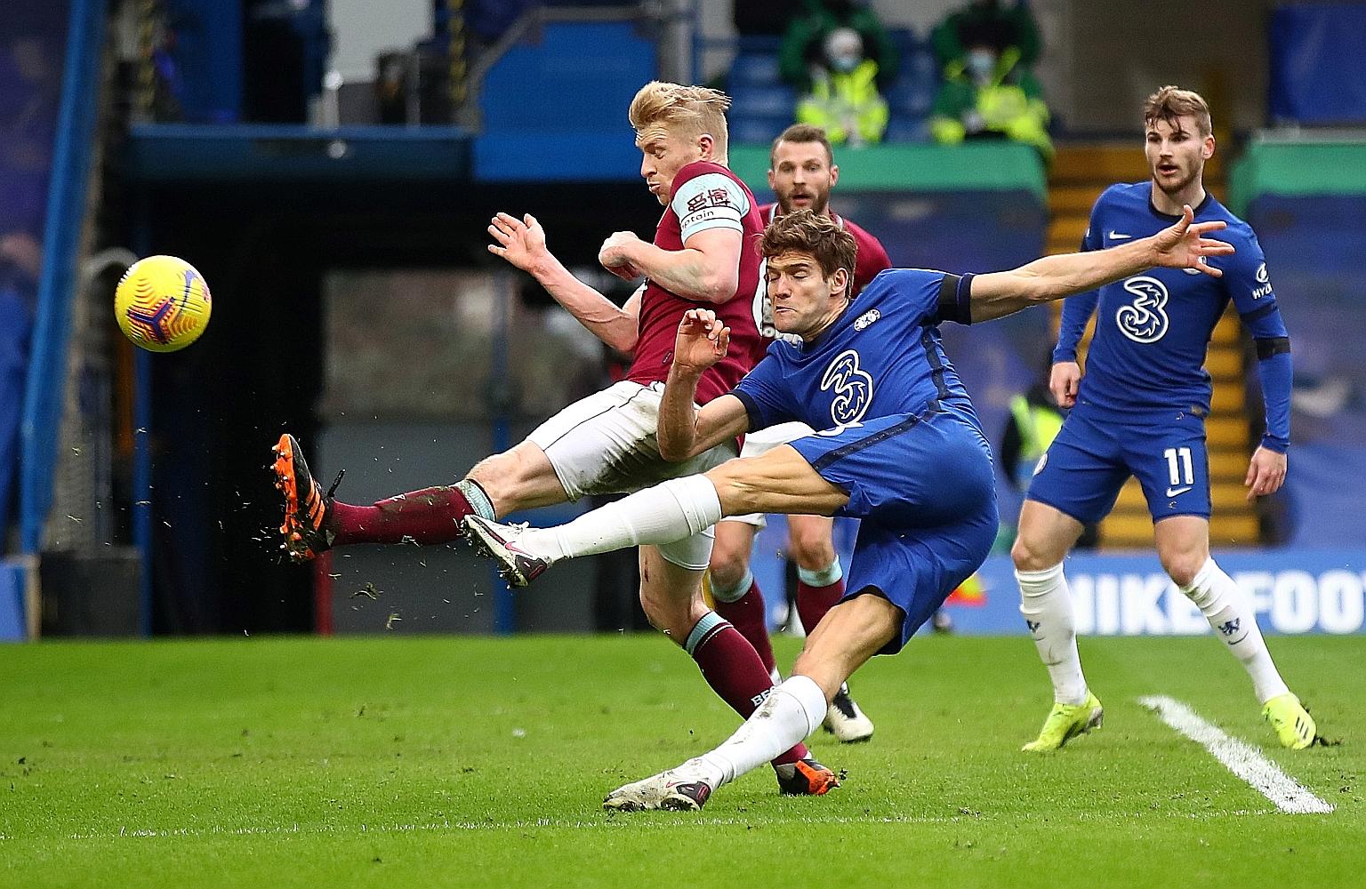 Defender Marcos Alonso volleying home to seal Chelsea's 2-0 Premier League win over Burnley yesterday at Stamford Bridge.