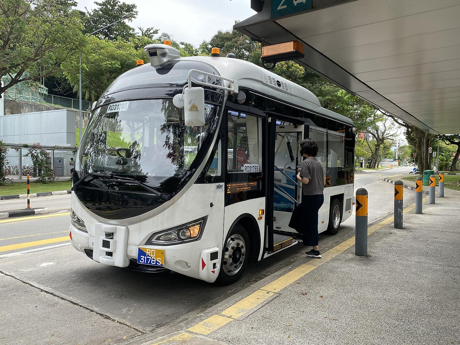 Japanese housewife Satoko Nemoto, 43, boarding a driverless bus at Haw Par Villa last Wednesday. The Haw Par Villa round-trip route is one of two trials here.