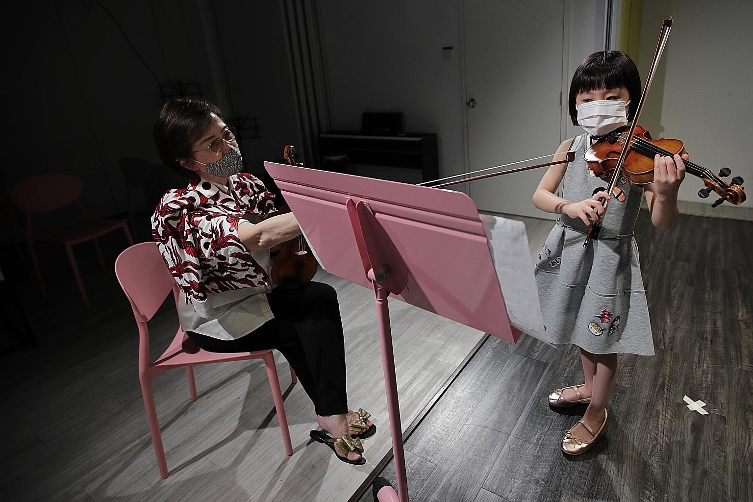 Six-year-old Gemmi Lim, with Wolfgang Violin Studio principal Annie Lee, was among the first here to take Trinity College London's Grade 5 online exam.