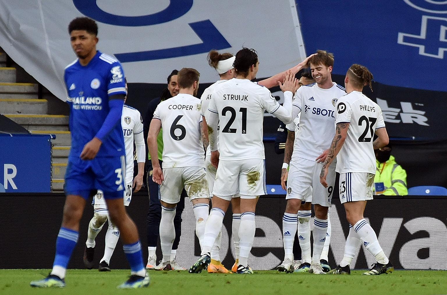 Leeds United's Patrick Bamford (second from far right) celebrating with teammates after scoring the go-ahead goal in their Premier League clash with Leicester at the King Power Stadium yesterday. The striker was involved in all of the away side's goa