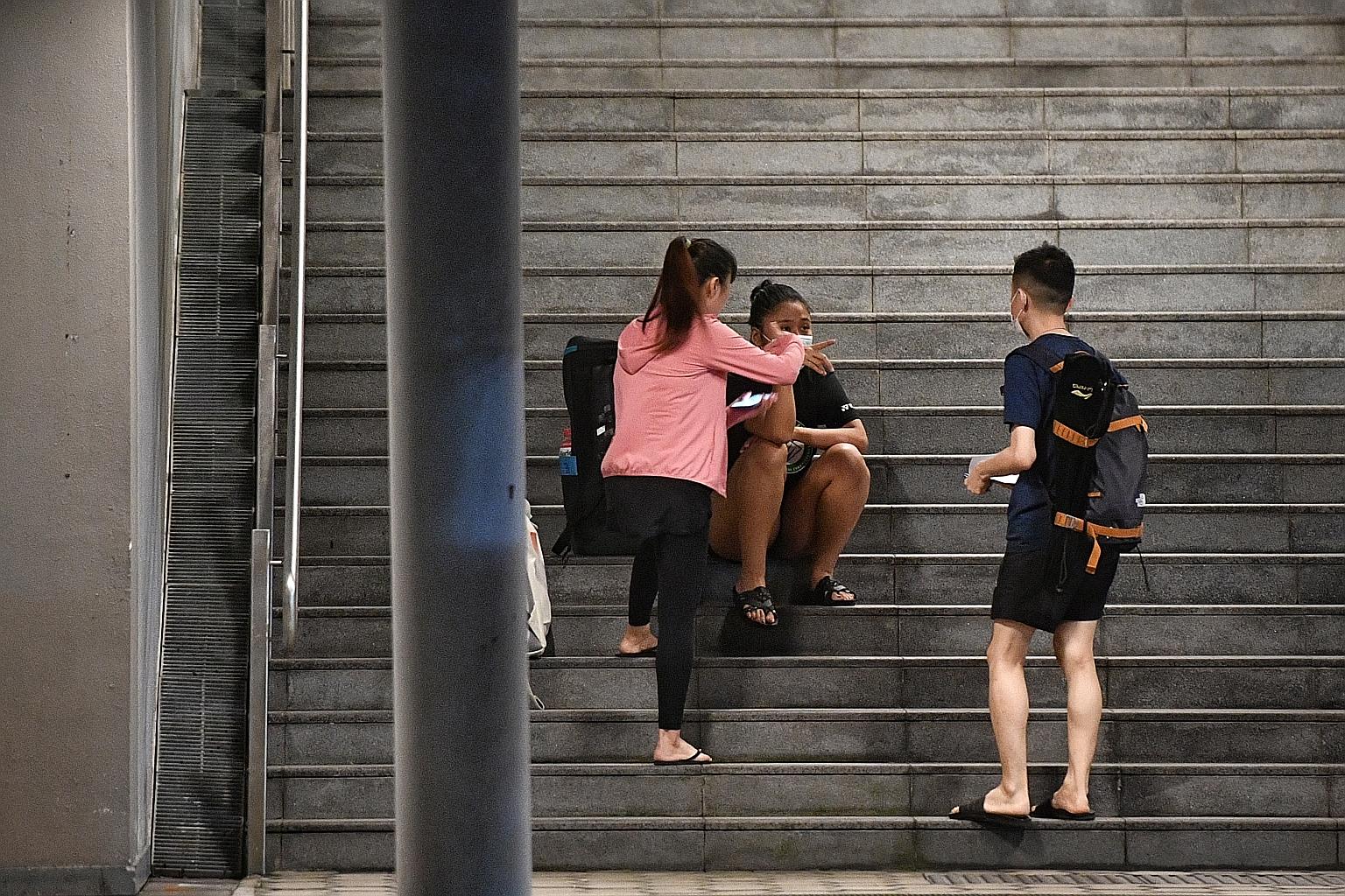 A man, who appears to be a reseller of court time, outside OCBC Arena. He takes money from the shuttlers, signs them in then leaves. ST PHOTO: ARIFFIN JAMAR