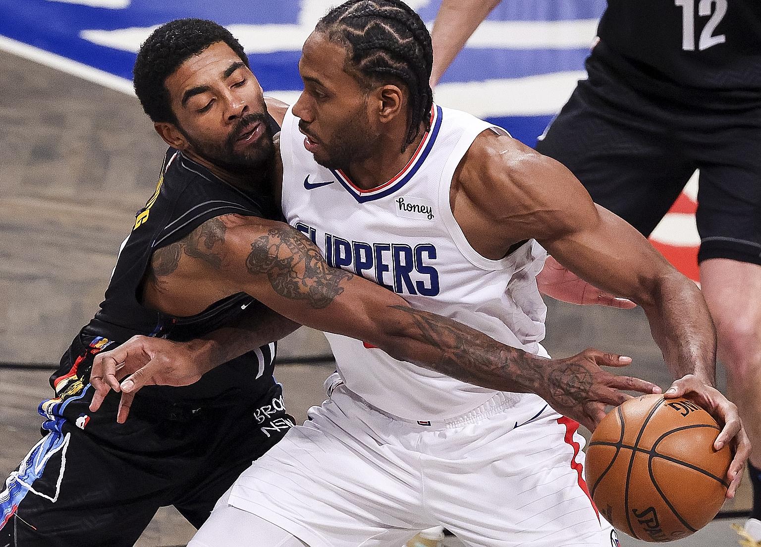 Nets' Kyrie Irving (left) putting in a 39-point effort to outshine Clippers' Kawhi Leonard, who had 33 points, in their NBA game on Tuesday.