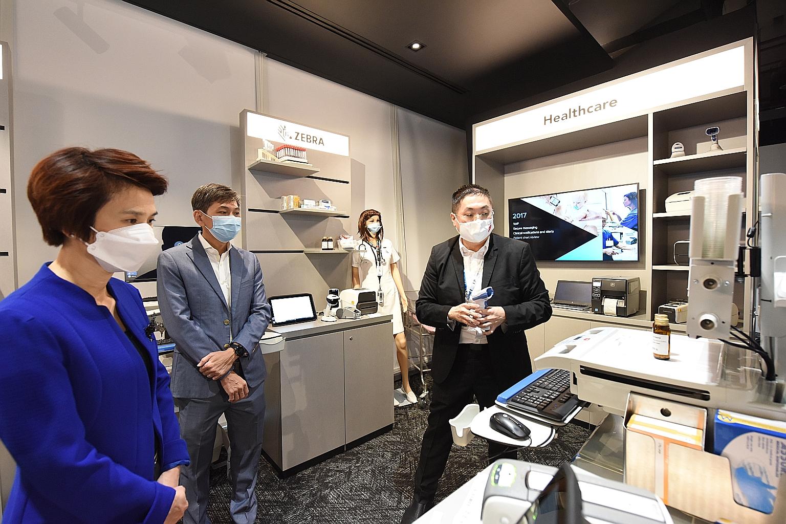 Minister of State for Trade and Industry Low Yen Ling, with Zebra Technologies Asia-Pacific vice-president and general manager Ryan Goh (centre) and vertical solutions lead Tan Aik Jin, on a tour of Zebra Technologies' new experience centre at the co