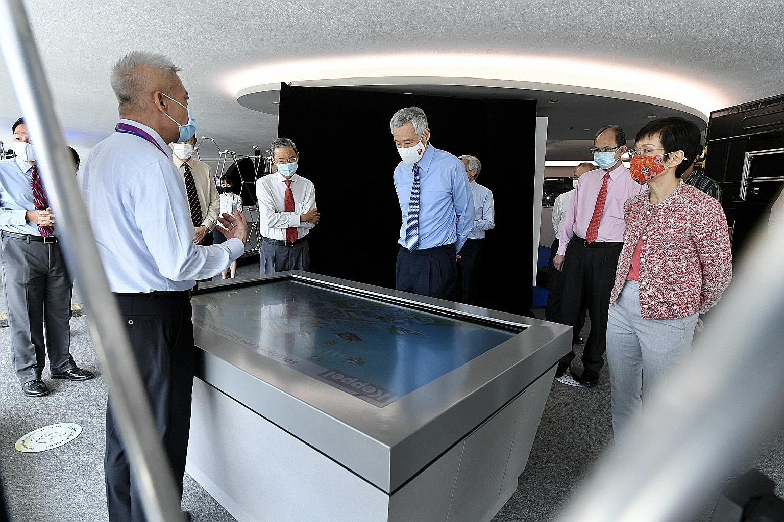 Prime Minister Lee Hsien Loong (centre) on a tour of the new Keppel Marina East Desalination Plant led by Keppel Infrastructure's executive director (projects) Goh Eng Kwang yesterday. With them were (from right) Minister for Sustainability and the E
