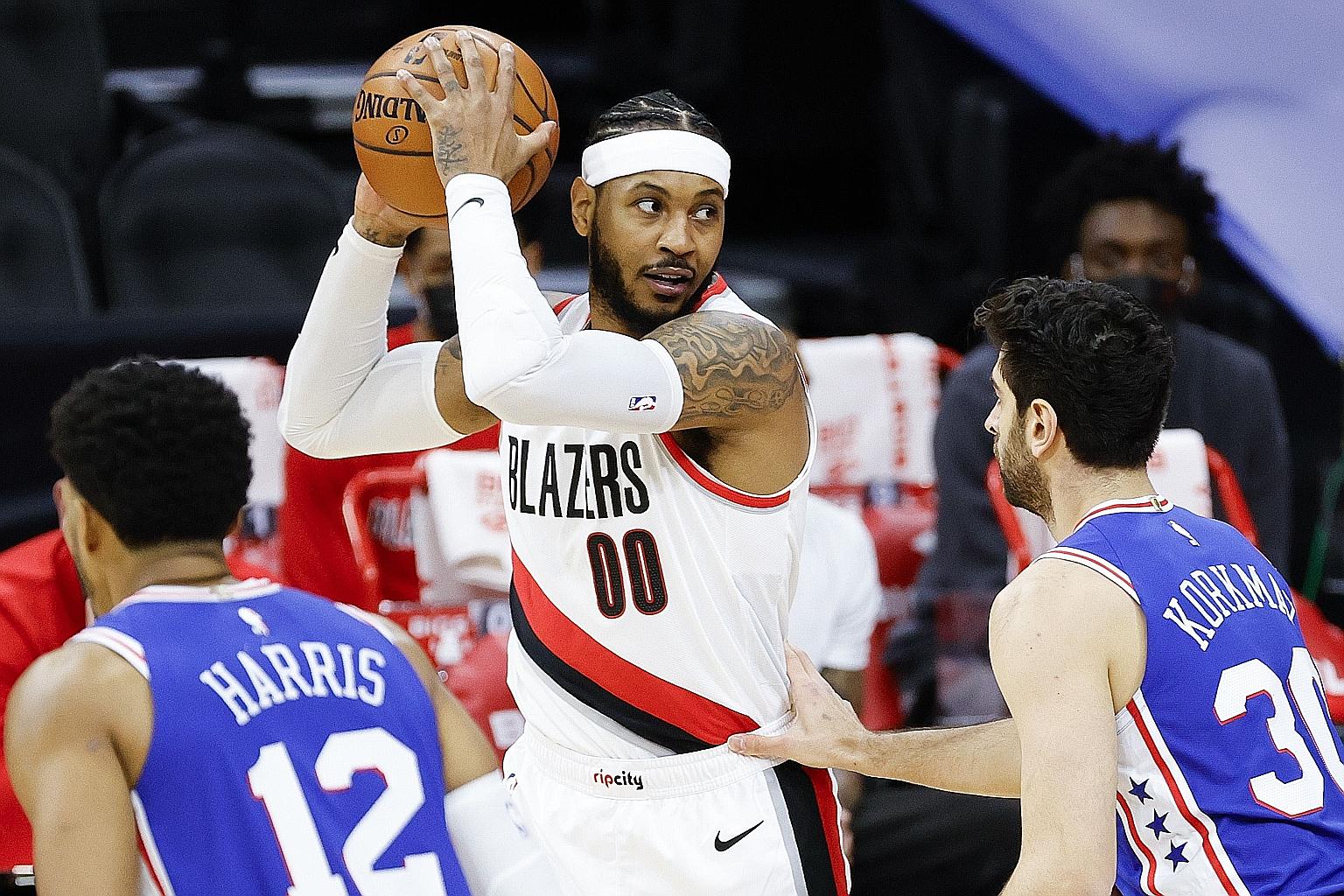 Carmelo Anthony (with ball) on the way to scoring 22 points to help Portland Trail Blazers stun Philadelphia 76ers 121-105.