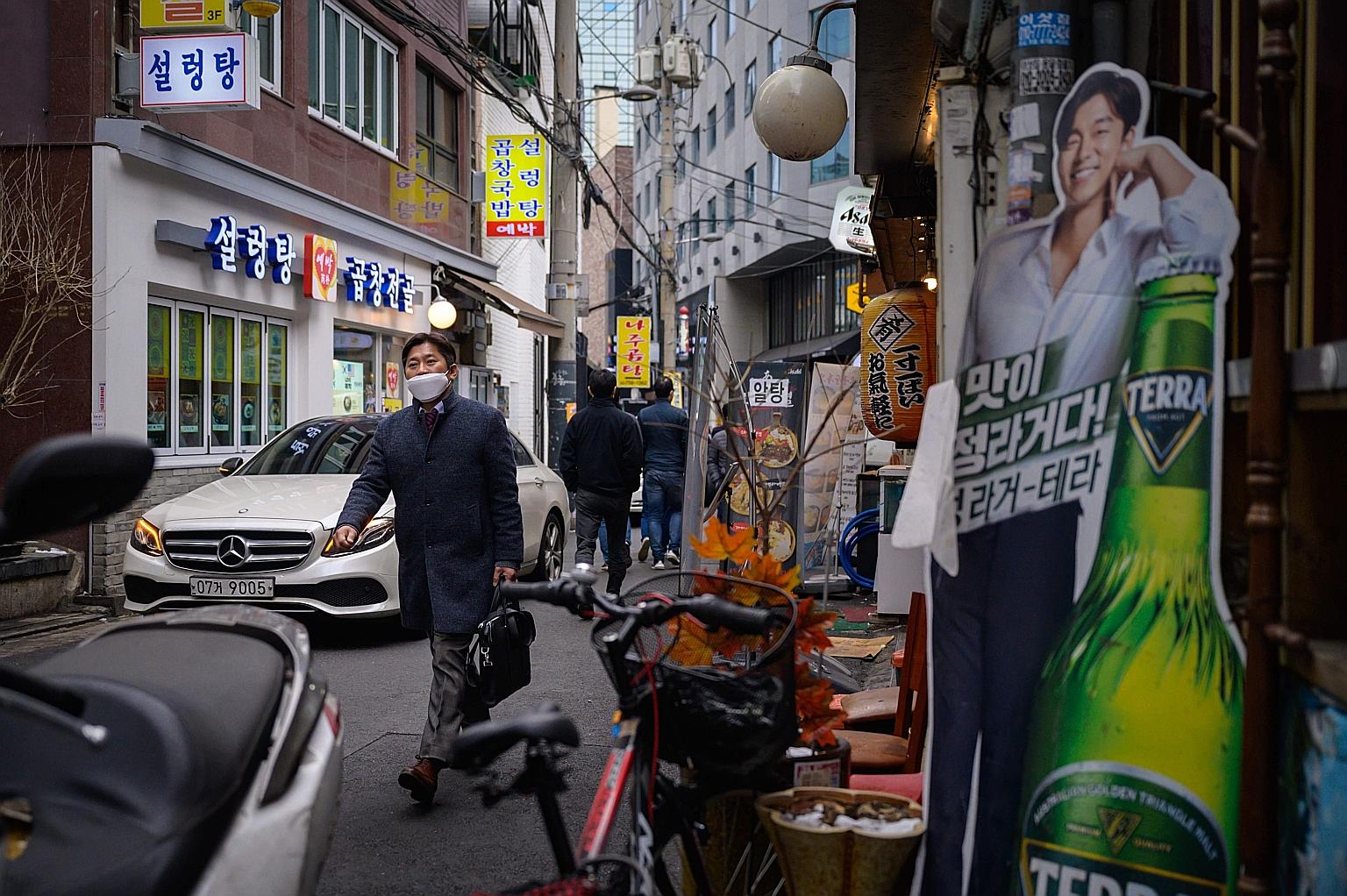 A restaurant-lined alleyway in Seoul on Friday. A 9pm operations restriction remains in the metropolitan Seoul area, where more than 70 per cent of South Korea's coronavirus infections are concentrated.