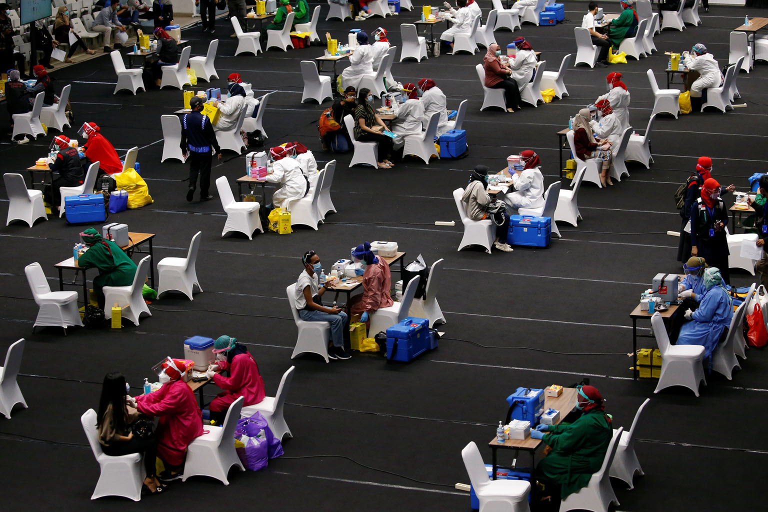 A mass vaccination for medical workers at Istora Senayan indoor stadium in Jakarta on Thursday. While Vietnam and Thailand will not be sufficiently immune until the middle of next year at the earliest, Indonesia's ambition to vaccinate 181.5 million