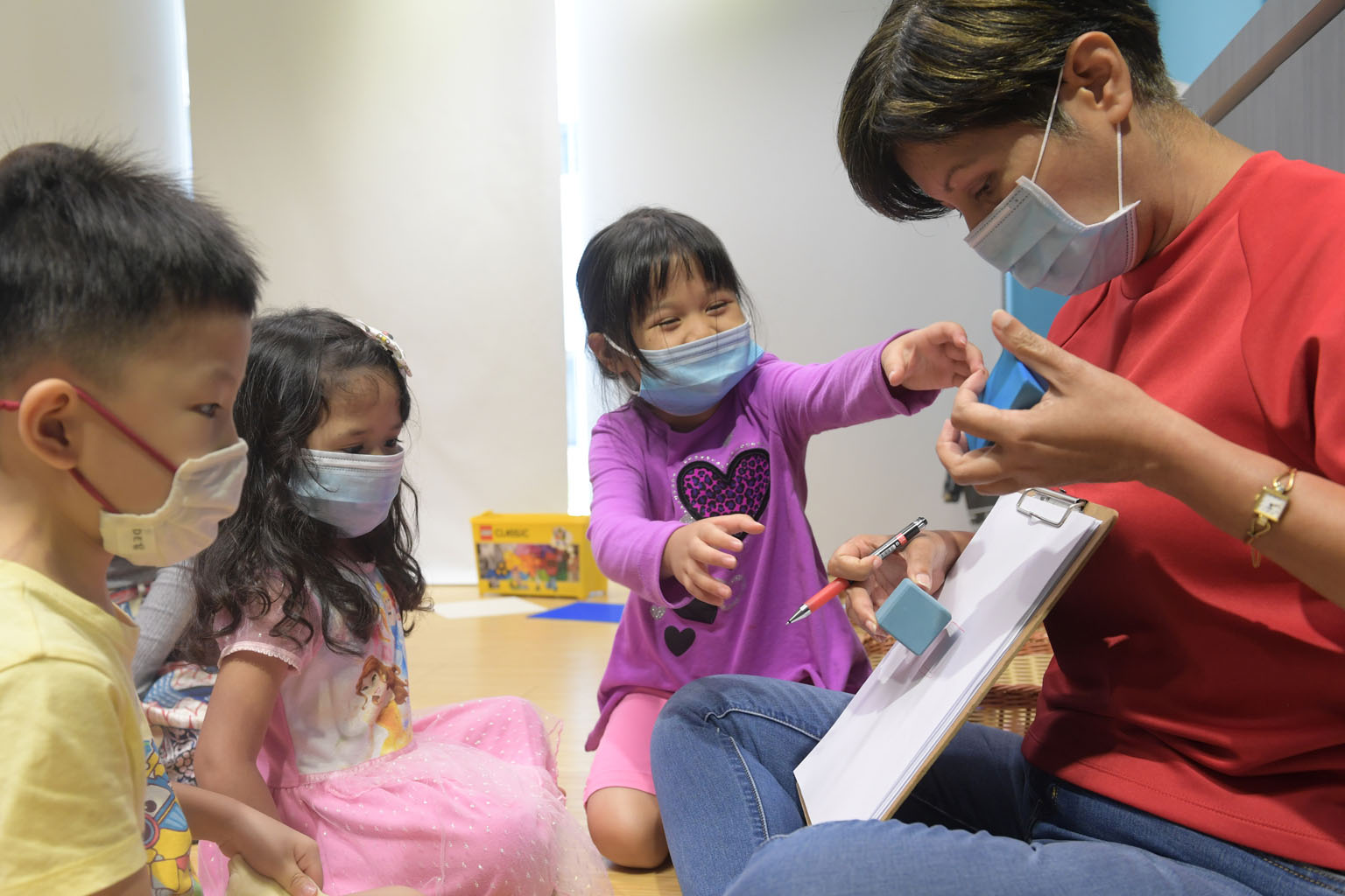 Second Minister for Finance Indranee Rajah participating in an activity yesterday with child beneficiaries at Kin@11, a programme space in York Hill under the Community Link initiative, which provides support to an estimated 1,000 low-income families