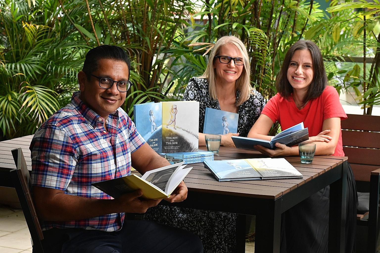 (From far left) Shameer Bismilla, Barbara Moxham and Leila Boukarim are behind the children's books, The Boy And The Box and The Girl And The Box.