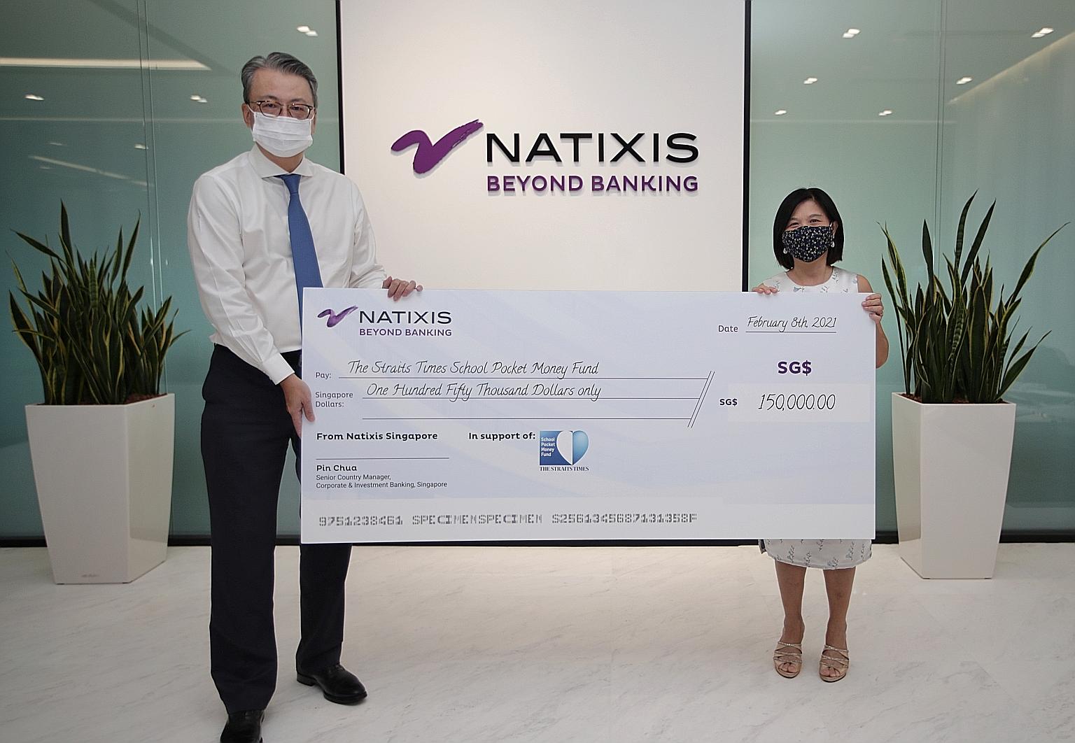 Mr Pin Chua, Natixis' senior country manager of Singapore and head of South-east and South Asia for corporate and investment banking, presenting the financial services firm's donation to The Straits Times School Pocket Money Fund's general manager Ta