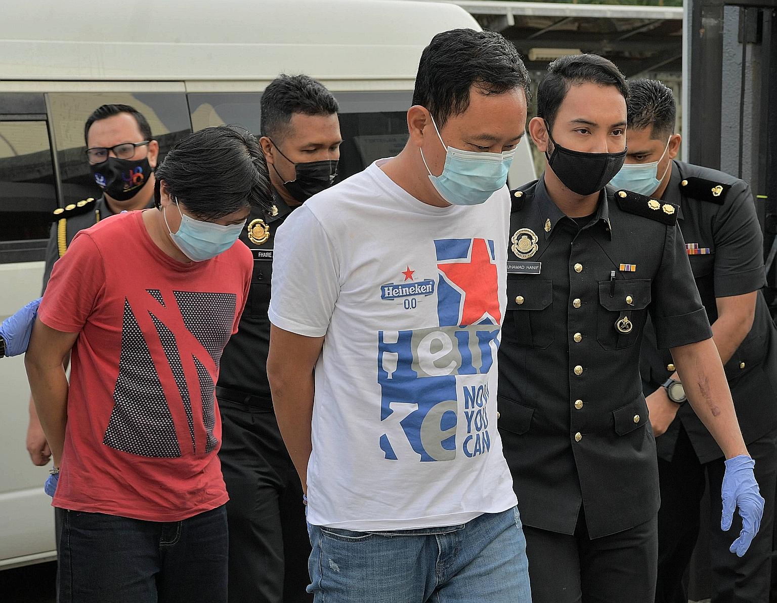 Yong Chee Keong (left) and Chong Kim Kuang, respectively the director and manager of a frozen food firm based in Senai, Johor, are accused of using fake halal logos on dozens of packages of meat not certified to be halal.