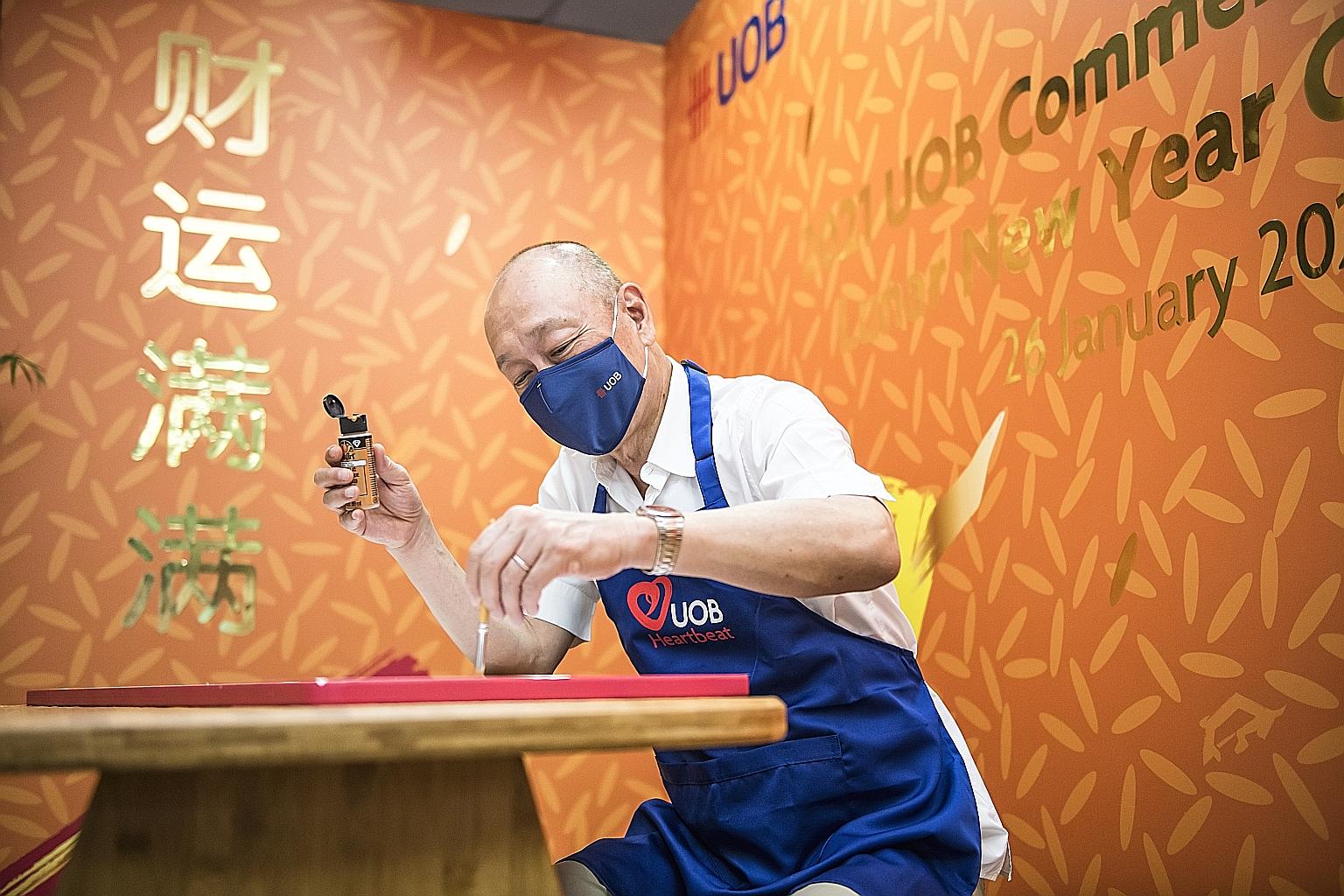 UOB deputy chairman and chief executive Wee Ee Cheong applying the finishing touches to his bamboo craft work during the bank's festive fund-raising drive this year.