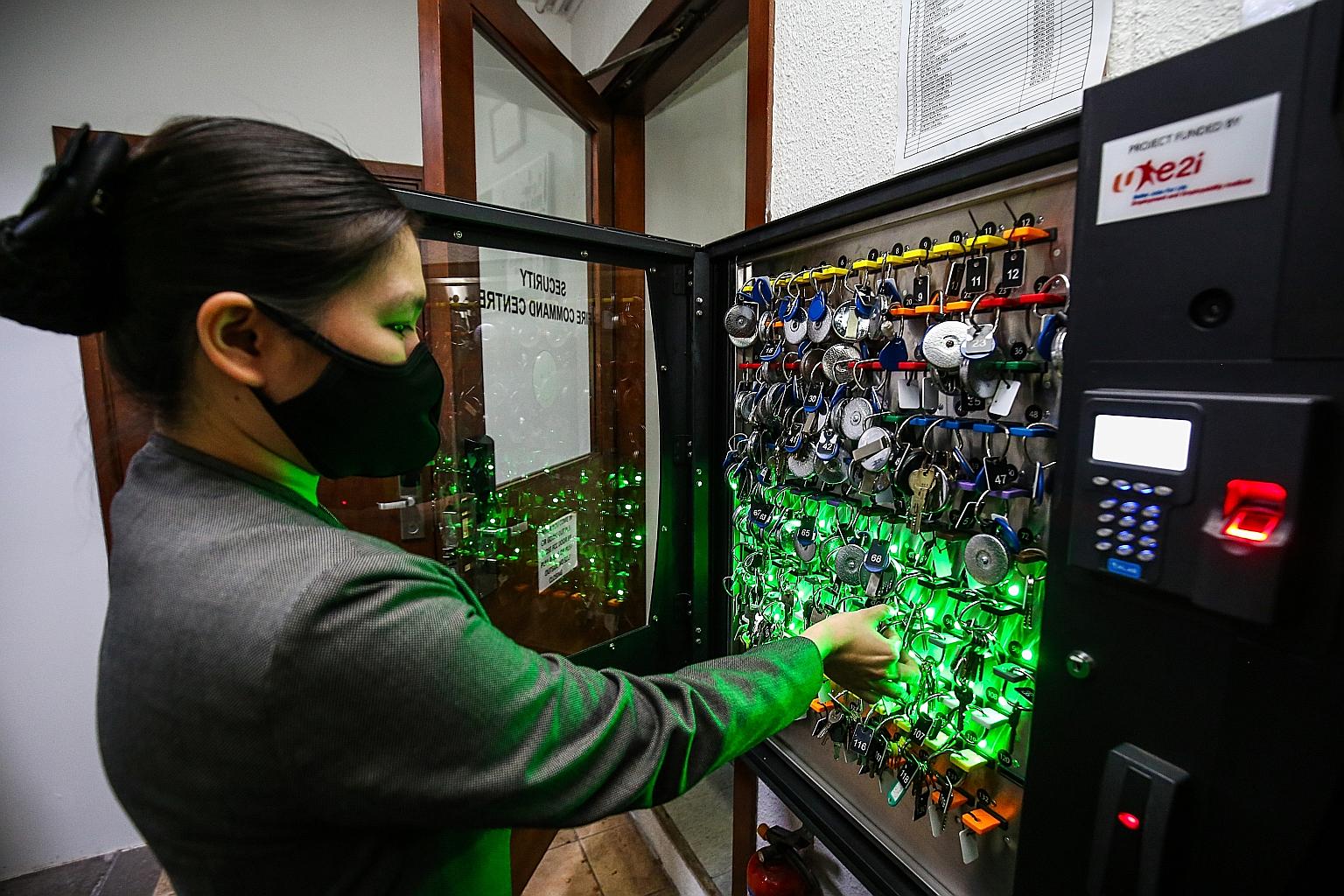 Miss Elsie Lee, a duty manager at Copthorne King's Hotel Singapore, showing how the key management system at the security fire command centre works. PHOTO: CMG