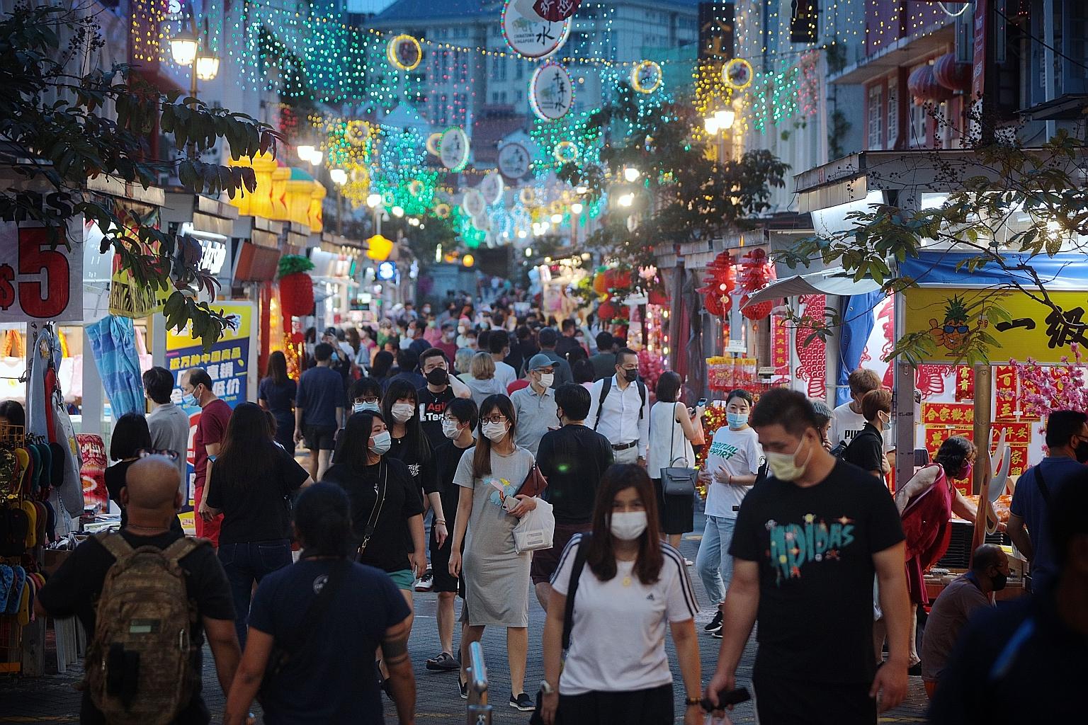 People in Chinatown on Jan 25. Concerned that too much mingling could lead to Covid-19 clusters forming and spreading rapidly, the Government has put new rules in place to minimise this as people get ready to mark Chinese New Year. ST PHOTO: JASON QU