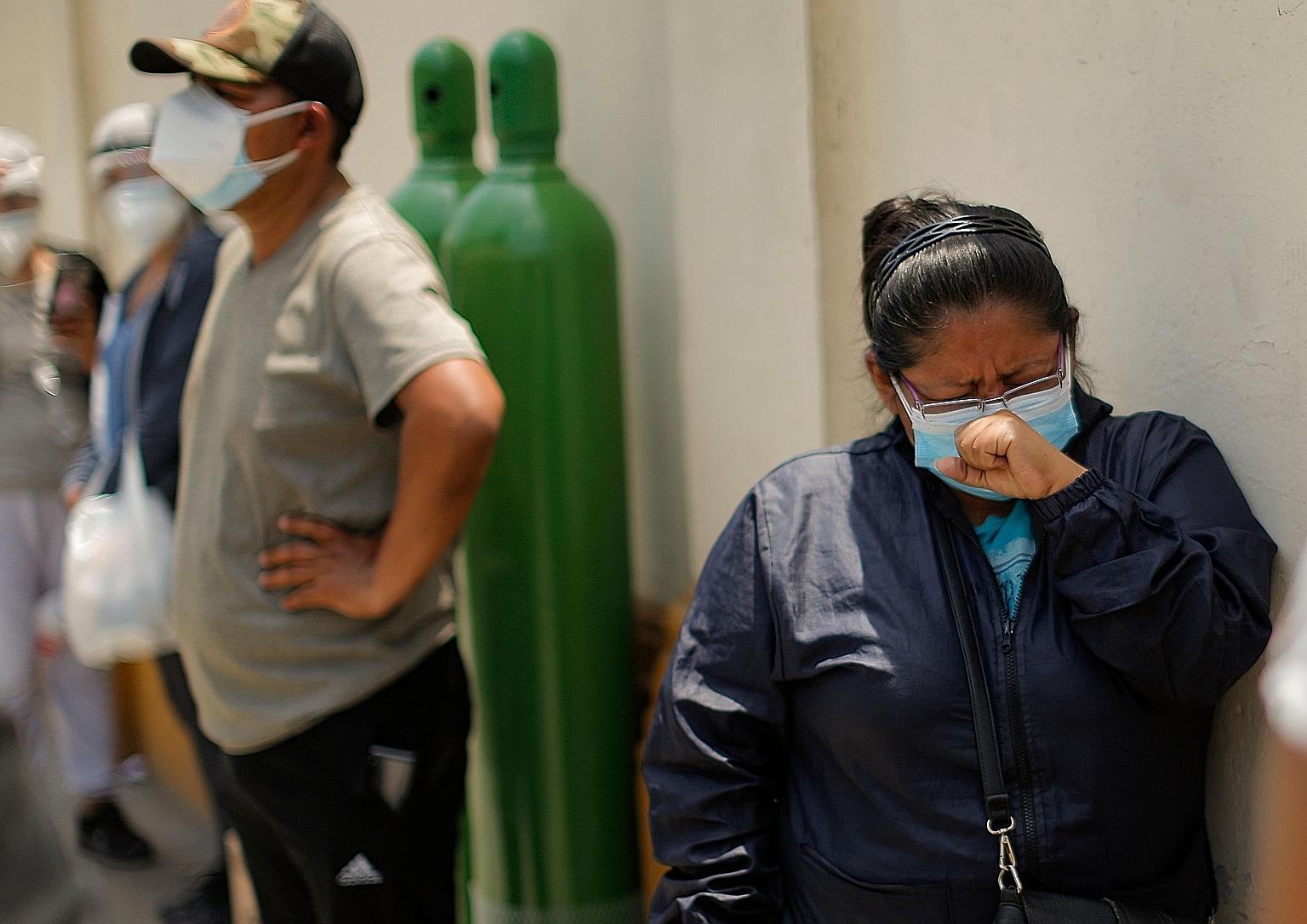 Relatives of Covid-19 patients queueing to refill oxygen tanks in Lima, Peru on Tuesday. As demand for oxygen soars across Latin America, prices have skyrocketed. PHOTO: AGENCE FRANCE-PRESSE
