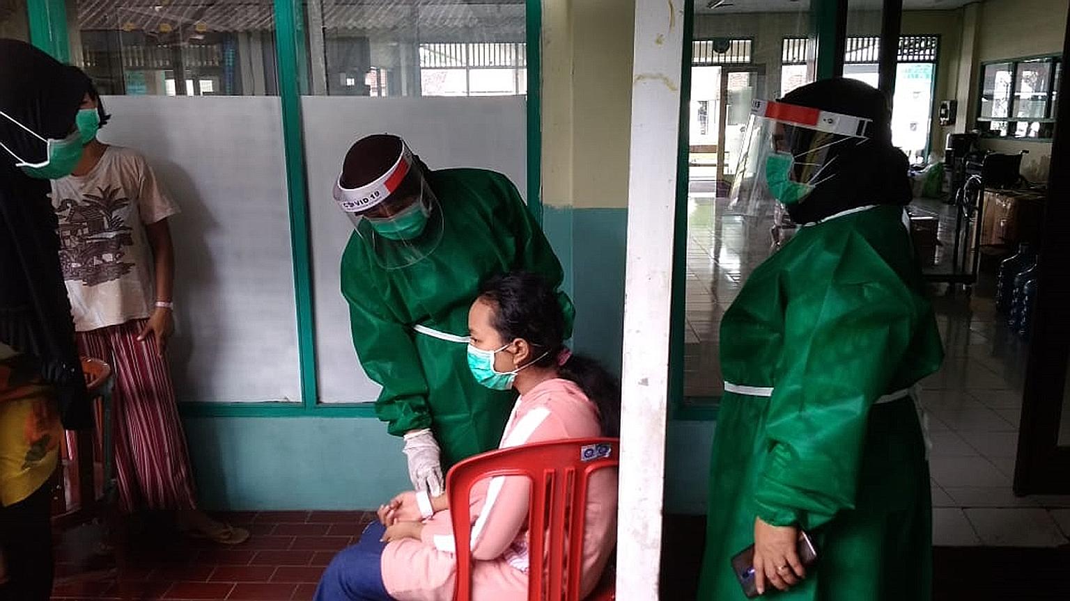 A patient being examined by doctors at a Covid-19 resilient shelter which Sonjo, a WhatsApp community group in Yogyakarta, helped to set up. In the spirit of mutual cooperation, volunteers helped patients to transfer between hospitals to ensure they