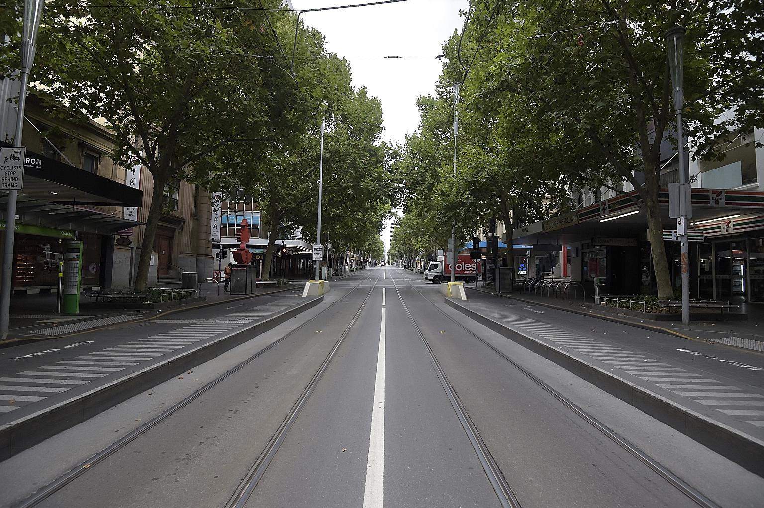 A deserted Swanston Street, the main thoroughfare of Melbourne's central business district, at the start of a five-day lockdown in Victoria's state capital yesterday.