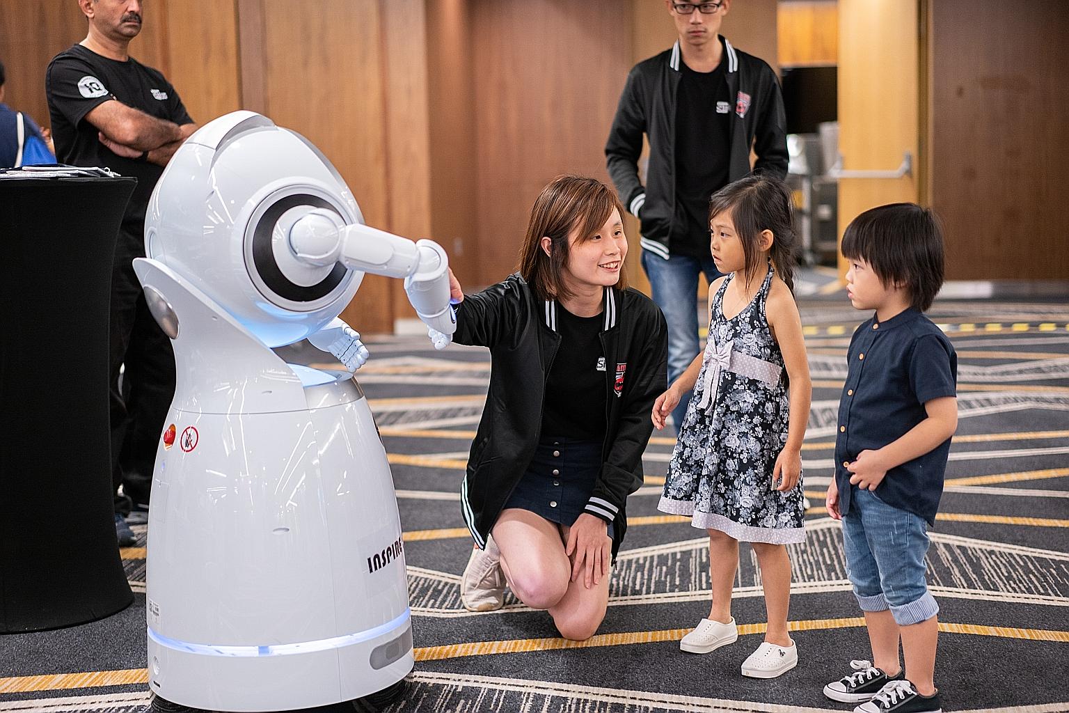 The Cruzr robot (left), which can give directions and information, was on show at Singapore Institute of Technology's open house last year.